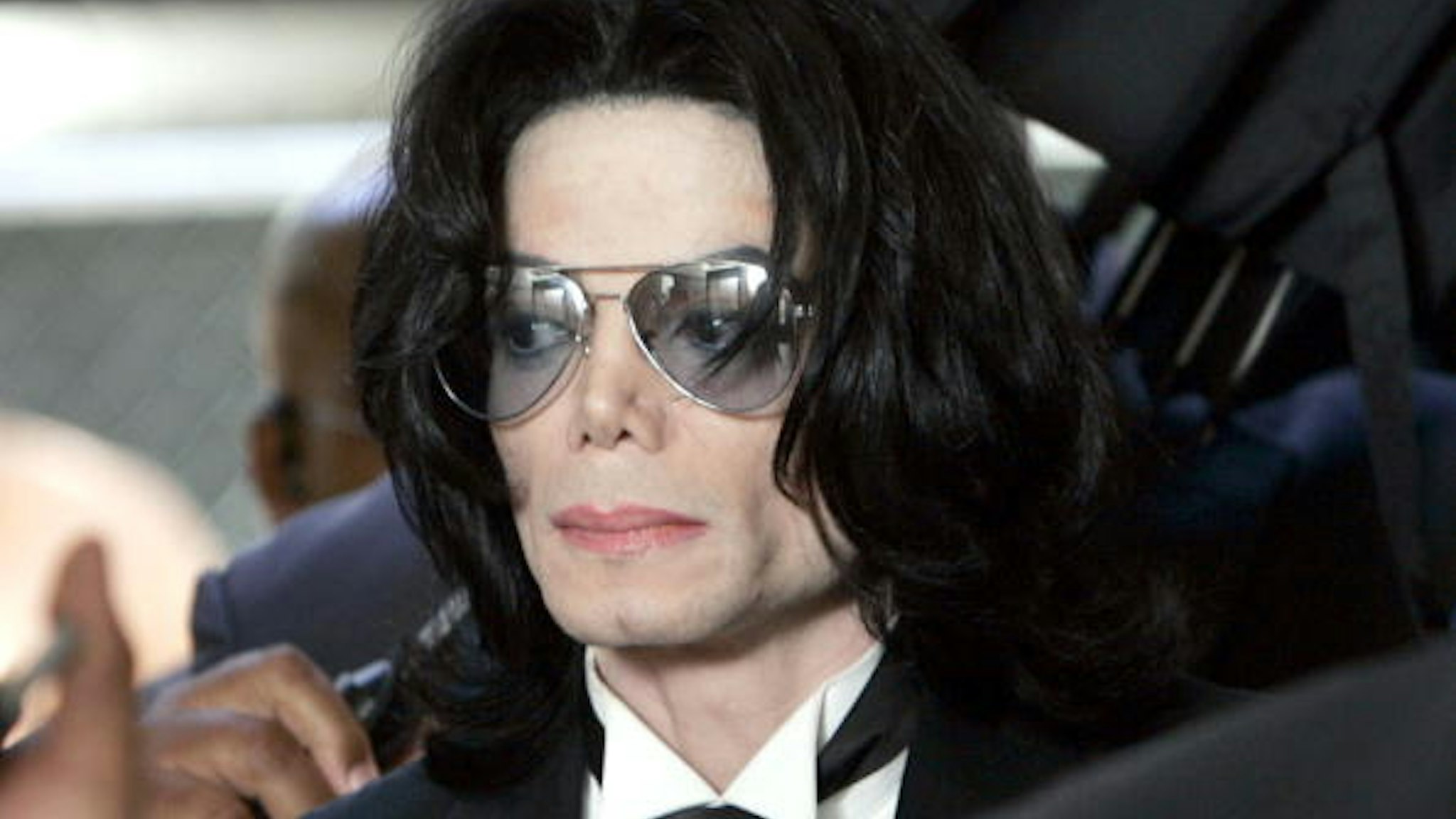SANTA MARIA, CA - JUNE 13: Michael Jackson prepares to enter the Santa Barbara County Superior Court to hear the verdict read in his child molestation case June 13, 2005 in Santa Maria, California. After seven days of deliberation the jury has reached a not guilty verdict on all 10 counts in the trial against Michael Jackson. Jackson was charged in a 10-count indictment with molesting a boy, plying him with liquor and conspiring to commit child abduction, false imprisonment and extortion. He pleaded innocent.