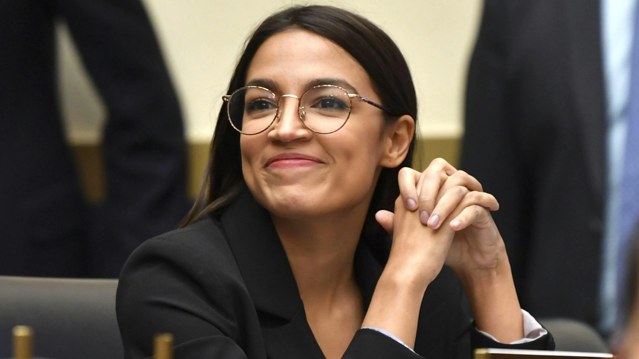Rep. Alexandria Ocasio-Cortez(D-NY) smiles as Facebook Chairman and CEO Mark Zuckerberg testifies before the House Financial Services Committee on "An Examination of Facebook and Its Impact on the Financial Services and Housing Sectors" in the Rayburn House Office Building in Washington, DC on October 23, 2019.