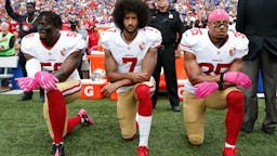 Eli Harold, Colin Kaepernick, Eric Reid Kneeling Eli Harold #58, Colin Kaepernick #7 and Eric Reid #35 of the San Francisco 49ers kneel in protest on the sideline, during the anthem, prior to the game against the Buffalo Bills at New Era Field on October 16, 2016 in Orchard Park, New York.