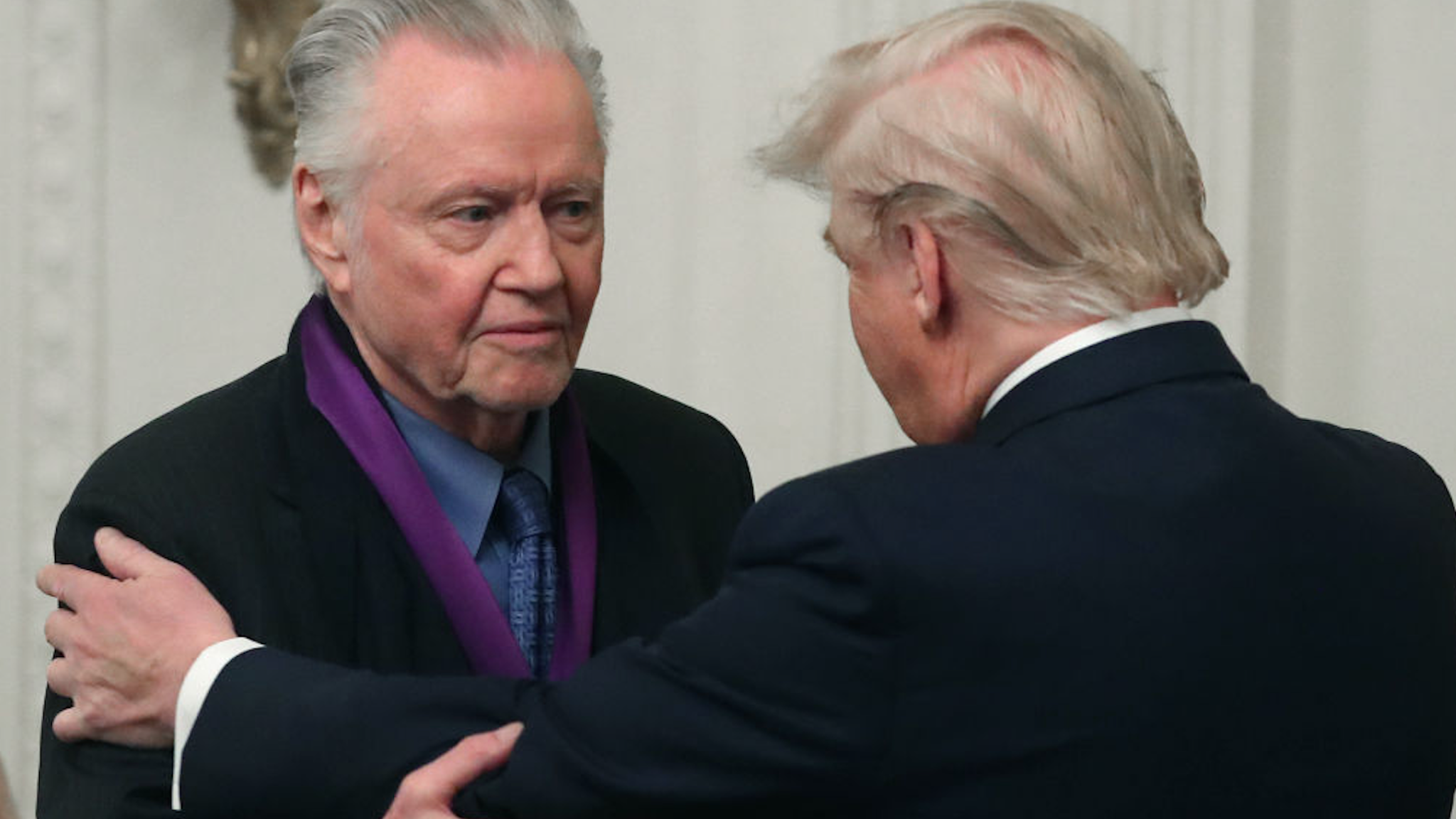U.S. President Donald Trump (R) presents actor Jon Voight with the National Medal of Arts during a ceremony in the East Room of the Whit House on November 21, 2019 in Washington, DC.