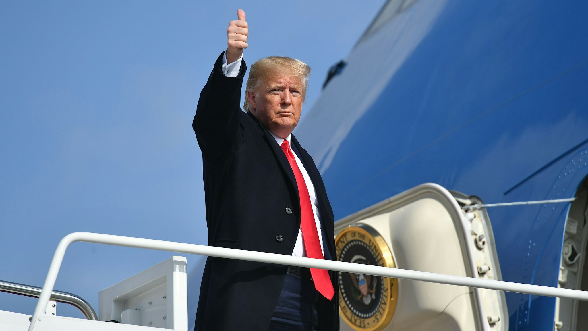 US President Donald Trump makes his way to board Air Force One before departing from Andrews Air Force Base in Maryland on November 20, 2019. - President Trump is heading to Austin to tour an Apple computer manufacturing facility.