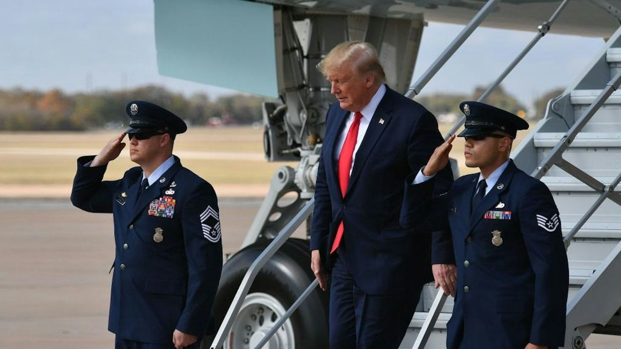 US President Donald Trump steps off Air Force One upon arrival at AustinBergstrom International Airport in Austin, Texas on November 20, 2019. - Trump is in Austin to tour an Apple computer manufacturing facility where the Mac Pro is assembled. (Photo by MANDEL NGAN / AFP)