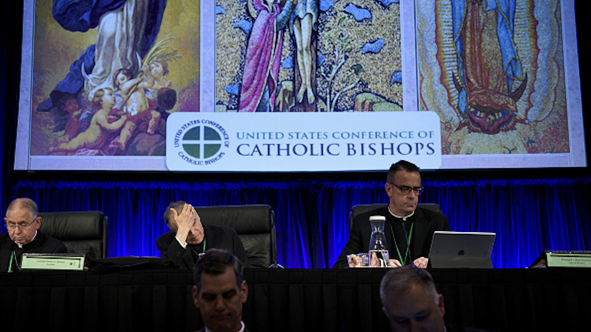 Reverend Jose Gomez (Top L), Archbishop of Los Angeles and Vice President of the USCCB General Assembly, Cardinal Daniel DiNardo (Top C), President of the USCCB General Assembly, Reverend Monsignor J. Brian Bransfield (Top R), General Secretary of the USCCB General Assembly, and others wait for an opening session during the annual US Conference of Catholic Bishops November 12, 2018 in Baltimore, Maryland.