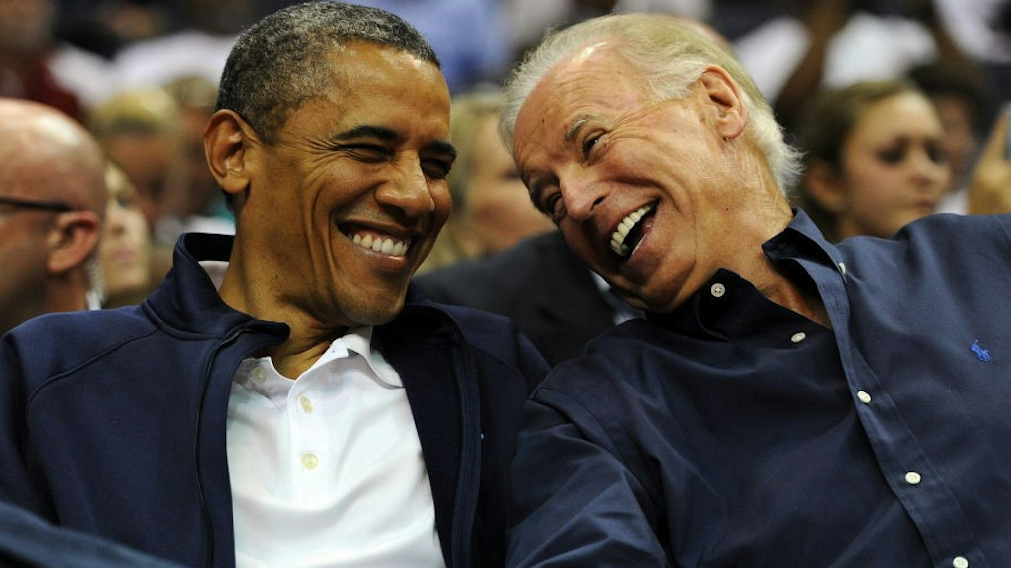 U.S. President Barack Obama and Vice President Joe Biden share a laugh as the US Senior Men's National Team and Brazil play during a pre-Olympic exhibition basketball game at the Verizon Center on July 16, 2012 in Washington, DC.