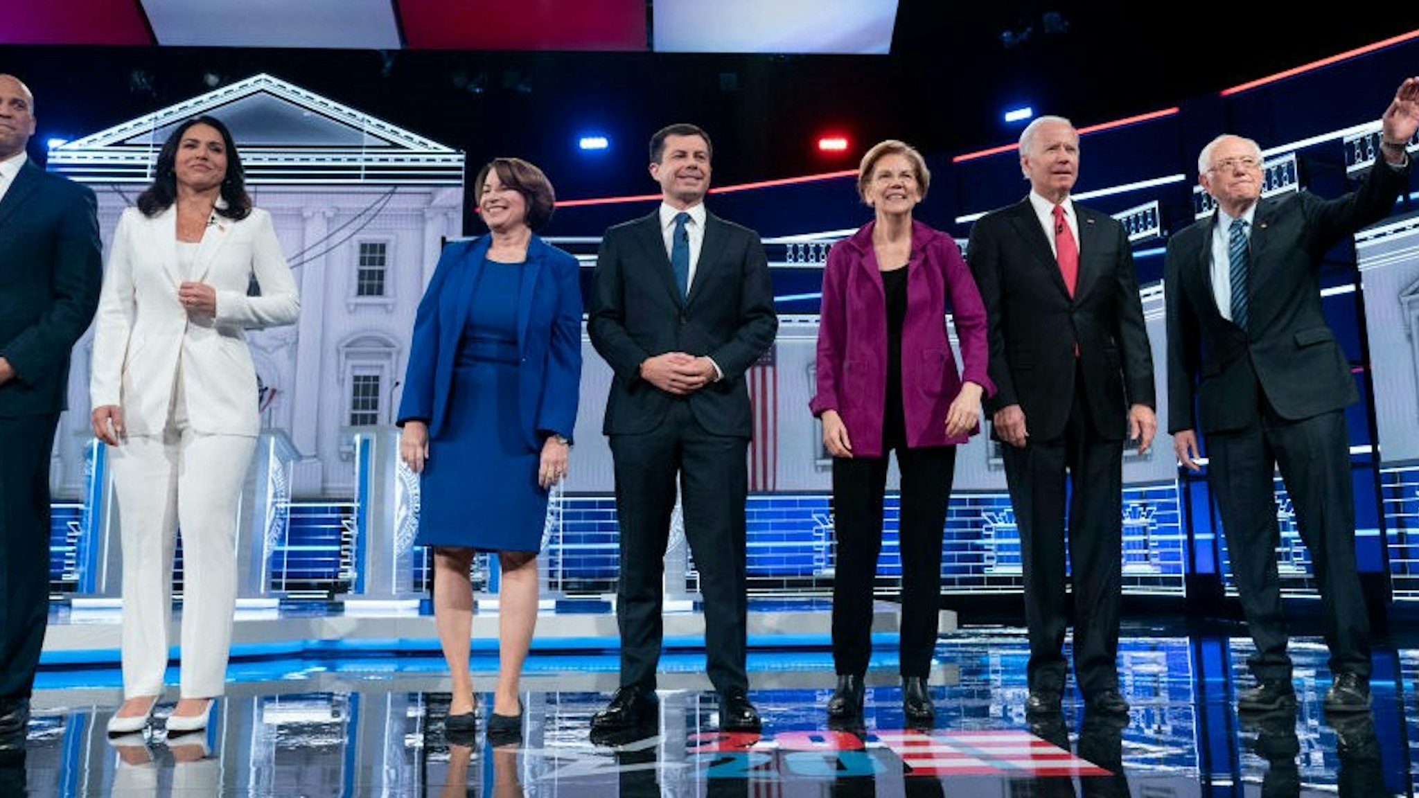 ATLANTA, GEORGIA - NOVEMBER 20: Presidential candidates Sen. Cory Booker (D-N.J.), Rep. Tulsi Gabbard (D-Hawaii), Sen. Amy Klobuchar (D-Minn.), South Bend, Ind., Mayor Pete Buttigieg, Sen. Elizabeth Warren (D-Mass.), Former vice president Joe Biden, and Sen. Bernie Sanders (I-Vt.) appear on stage at the start of he Democratic presidential debate at Tyler Perry Studios on Wednesday, November 20, 2019, in Atlanta, Georgia. The 10 qualifying candidates participated in the campaign seasons fifth debate, hosted by The Washington Post via Getty Images and MSNBC.(Photo by