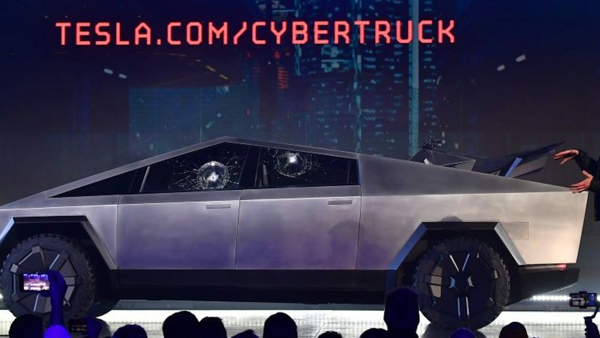 Tesla co-founder and CEO Elon Musk gestures while wrapping up his presentation of the newly unveiled all-electric battery-powered Tesla Cybertruck at Tesla Design Center in Hawthorne, California on November 21, 2019.