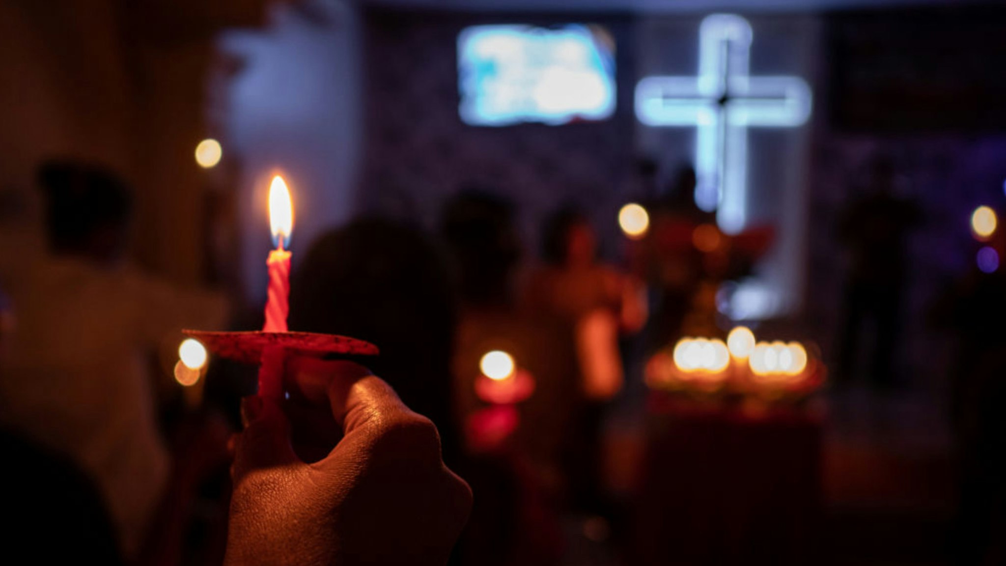 Christians hold candles during Christmas Eve mass at a church on December 25, 2018 in Carita, Banten province, Indonesia.