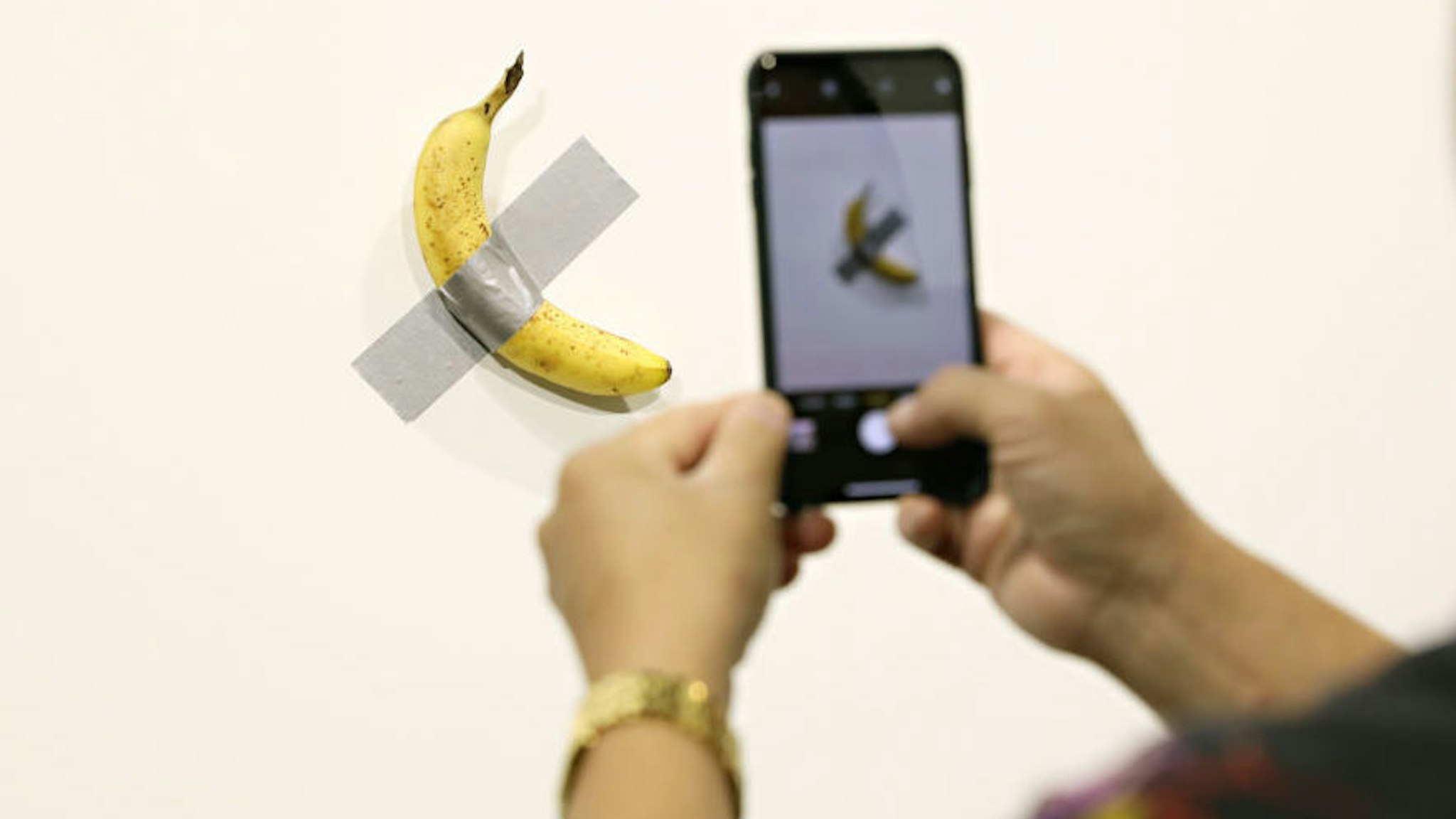 Maurizio Cattelan's "Comedian" presented by Perrotin Gallery and on view at Art Basel Miami 2019 at Miami Beach Convention Center on December 6, 2019 in Miami Beach, Florida. Two of the three editions of the piece, which feature a banana duct-taped to a wall, have reportedly sold for $120,000.