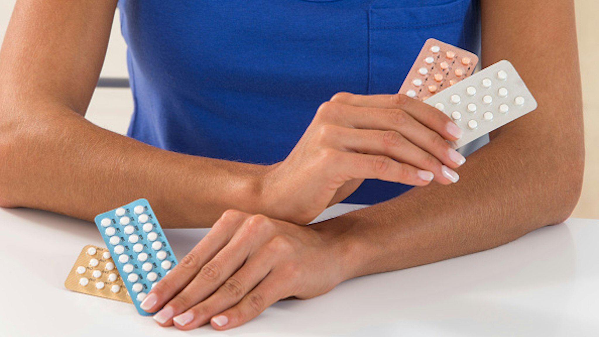 Woman holding contraceptive pills.