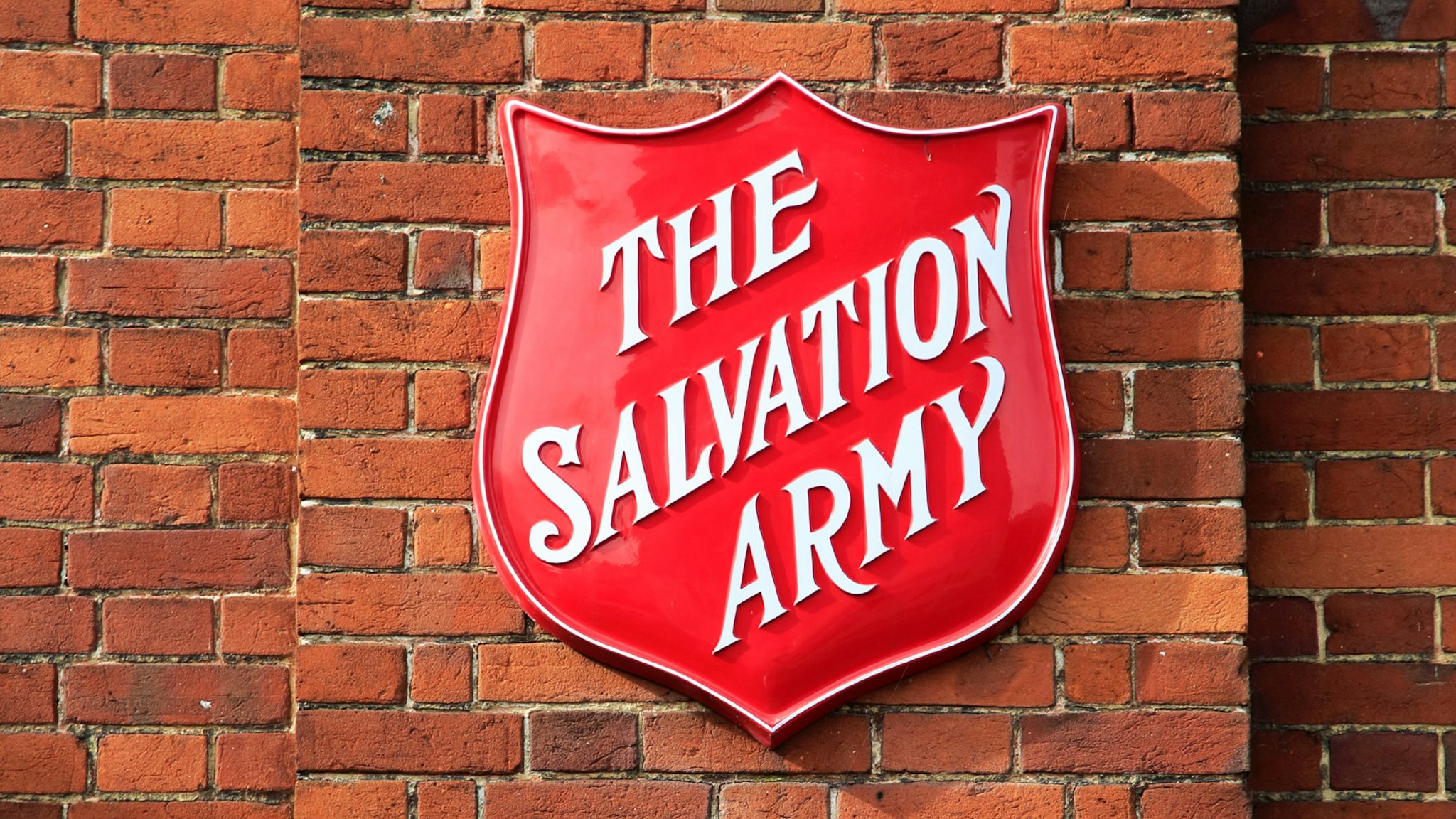 Salvation Army sign on brick wall, Andover, Hampshire, England.