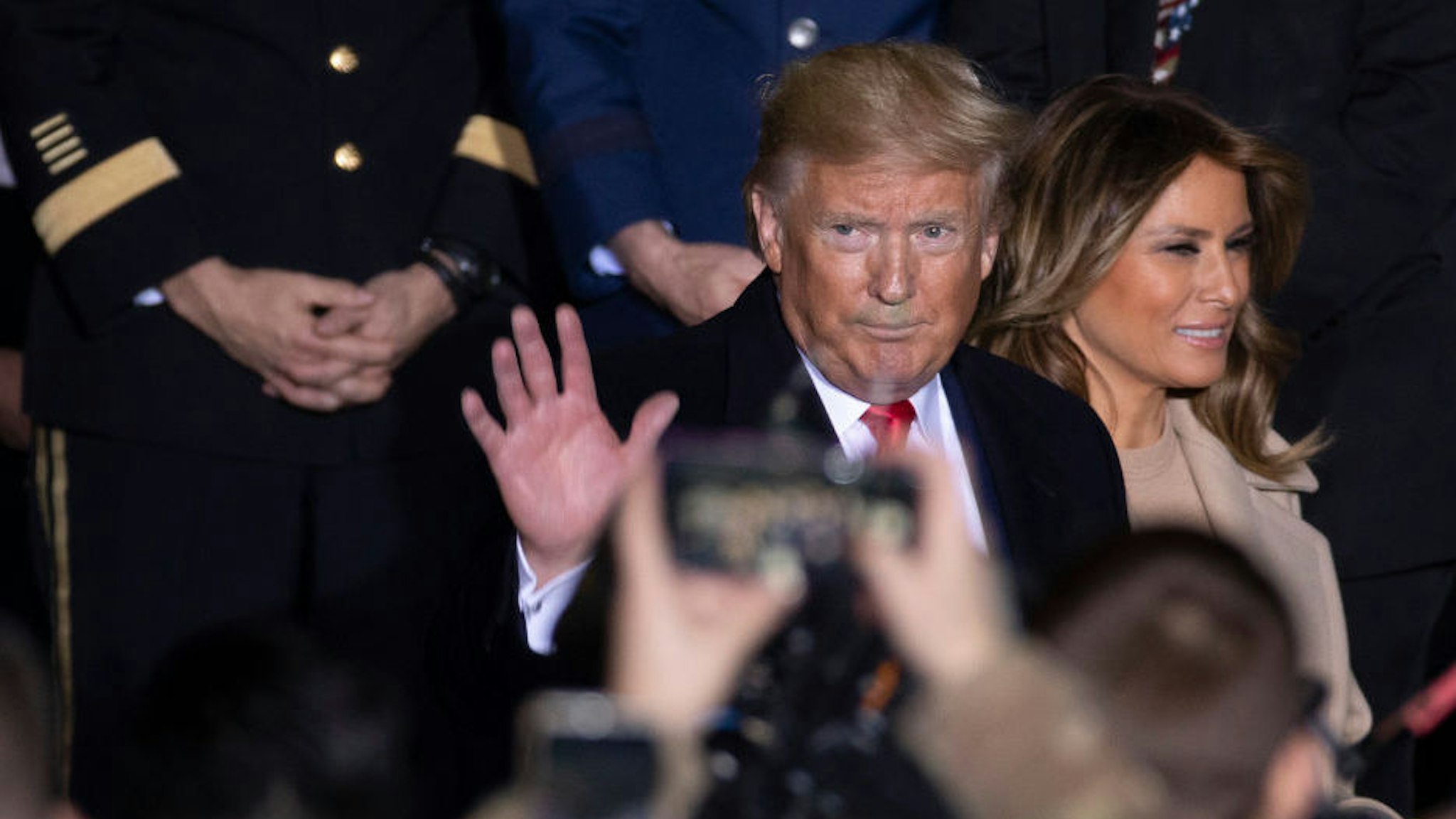 US President Donald Trump and First Lady Melania Trump greet troops at the signing ceremony for S.1709, The National Defense Authorization Act for Fiscal Year 2020 on December 20, 2019 in Joint Base Andrews, Maryland. President Trump is headed to Florida for the Holidays after a historic impeachment vote on the house floor this week. (Photo by Tasos Katopodis/Getty Images)