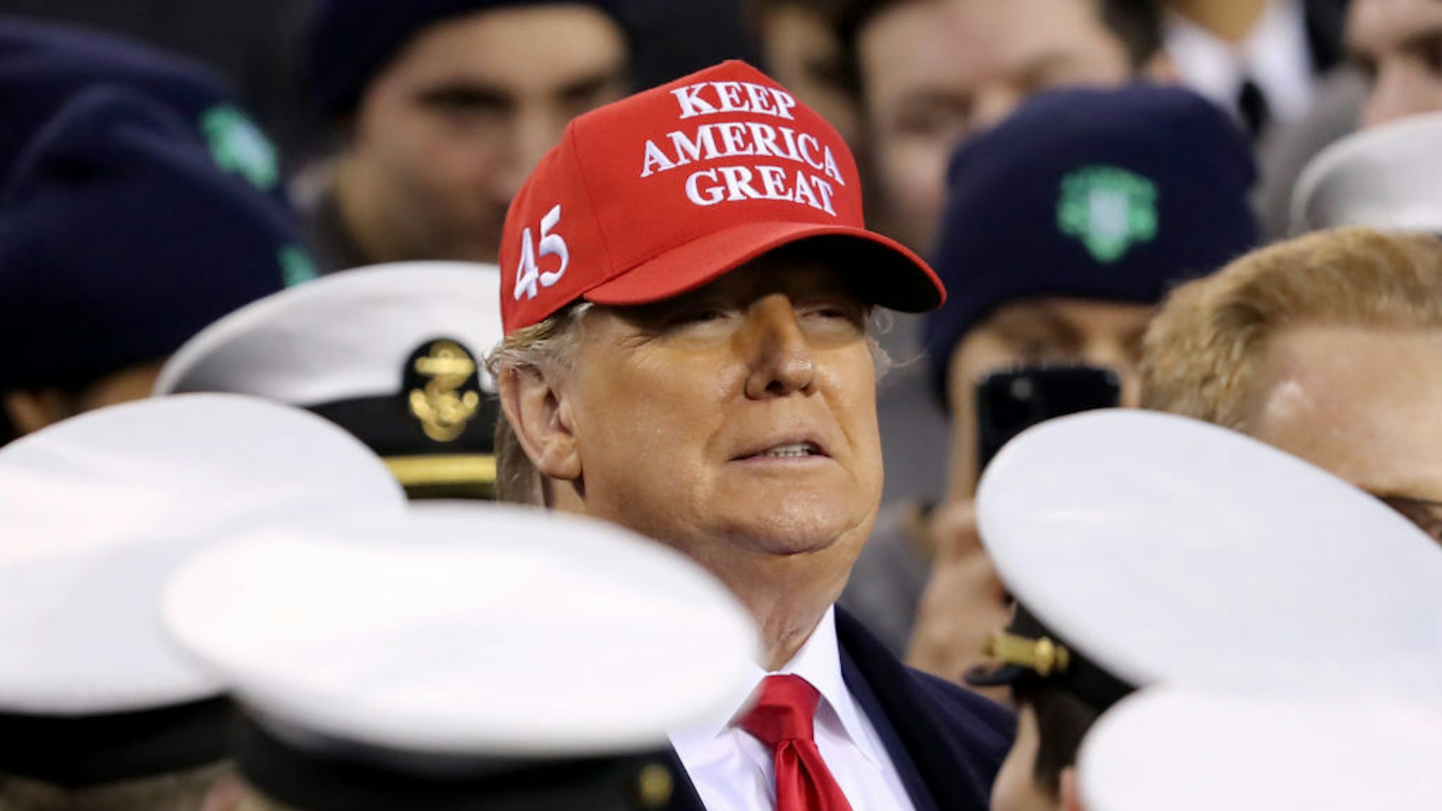 U.S. President Donald Trump stands with the Navy side of the field to start the second half of the game between the Army Black Knights and the Navy Midshipmen at Lincoln Financial Field on December 14, 2019 in Philadelphia, Pennsylvania. (Photo by Elsa/Getty Images)