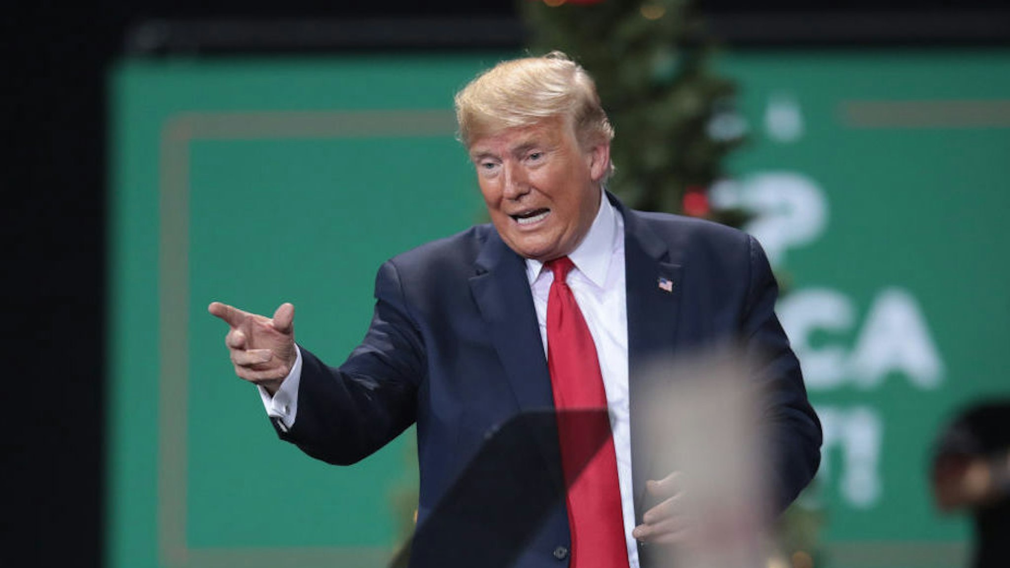 President Donald Trump leaves his Merry Christmas Rally at the Kellogg Arena on December 18, 2019 in Battle Creek, Michigan. While Trump spoke at the rally the House of Representatives voted, mostly along party lines, to impeach the president for abuse of power and obstruction of Congress, making him just the third president in U.S. history to be impeached. (Photo by Scott Olson/Getty Images)