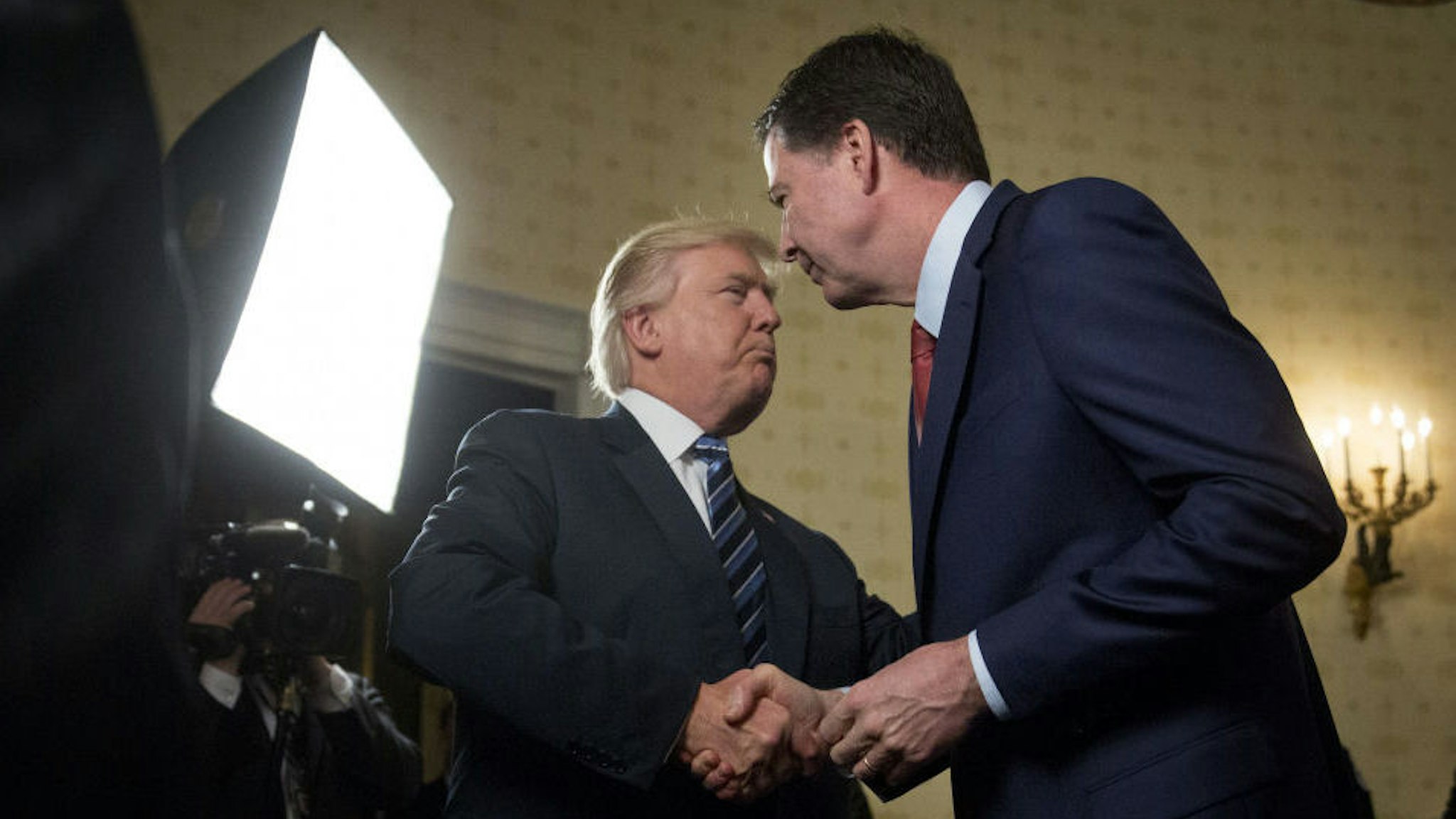 President Donald Trump, left, shakes hands with James Comey, director of the Federal Bureau of Investigation (FBI), during an Inaugural Law Enforcement Officers and First Responders Reception in the Blue Room of the White House in Washington, D.C., U.S., on Sunday, Jan. 22, 2017. The one year anniversary of U.S. President Donald Trump's inauguration falls on Saturday, January 20, 2018. Our editors select the best archive images looking back over Trump’s first year in office. Photographer: Andrew Harrer/Bloomberg