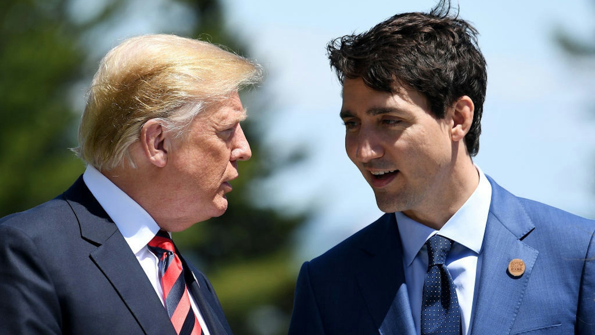 Prime Minister of Canada Justin Trudeau (R) speaks with U.S. President Donald Trump during the G7 official welcome at Le Manoir Richelieu on day one of the G7 meeting on June 8, 2018 in Quebec City, Canada. Canada will host the leaders of the UK, Italy, the US, France, Germany and Japan for the two day summit, in the town of La Malbaie. (Photo by Leon Neal/Getty Images)