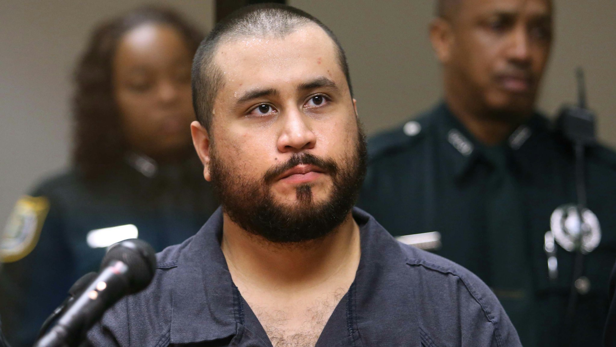 SANFORD, FL - NOVEMBER 19: George Zimmerman, the acquitted shooter in the death of Trayvon Martin, faces a Seminole circuit judge during a first-appearance hearing on charges including aggravated assault stemming from a fight with his girlfriend November 19, 2013 in Sanford, Florida. Zimmerman, 30, was arrested after police responded to a domestic disturbance call at a house. He was acquitted in July of all charges in the shooting death of unarmed, black teenager, Trayvon Martin.