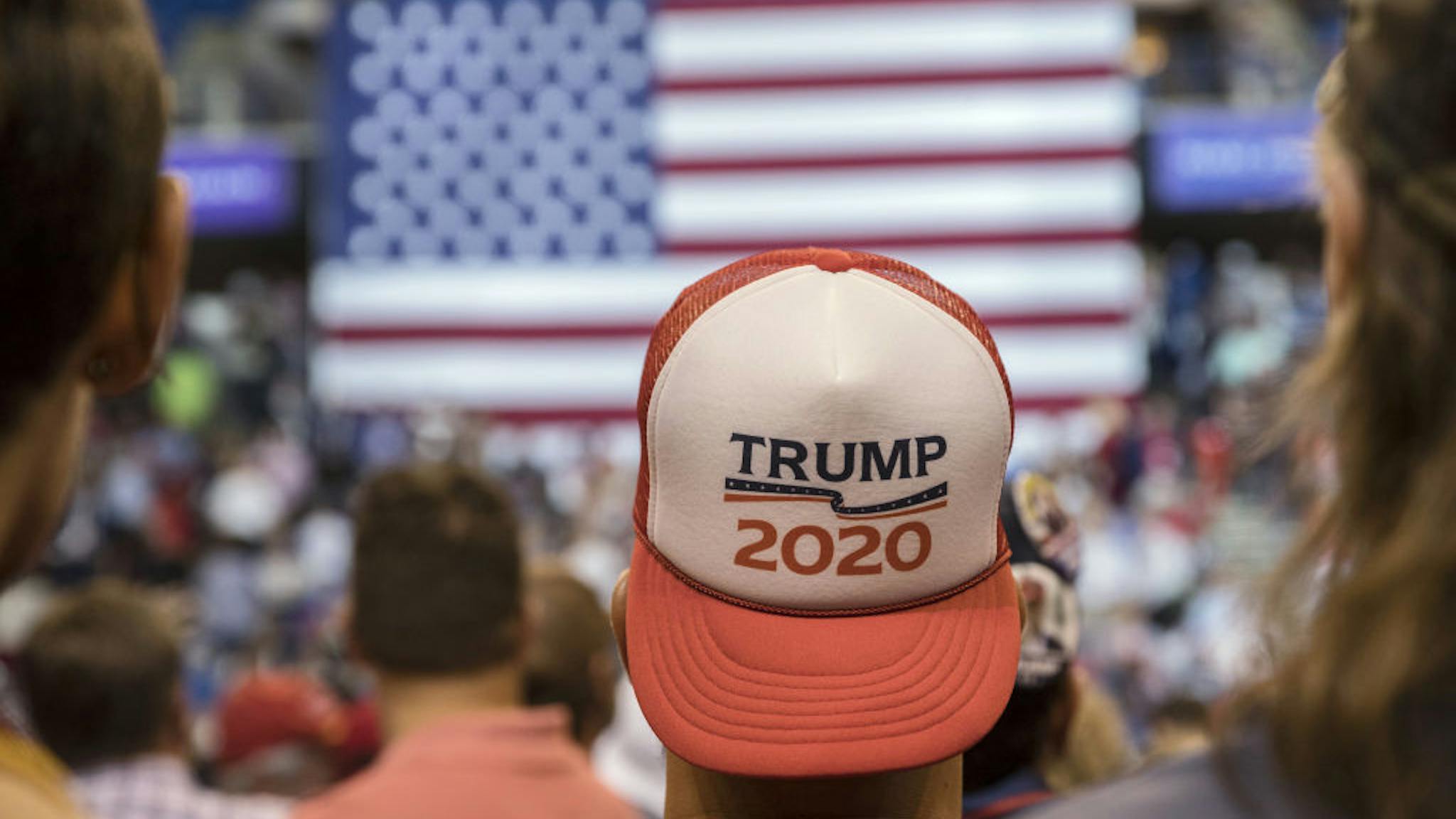 President Trump Holds MAGA Rally An attendee wears a "Trump 2020" hat before the start of a rally with U.S. President Donald Trump in Wilkes-Barre, Pennsylvania, U.S., on Thursday, Aug. 2, 2018.