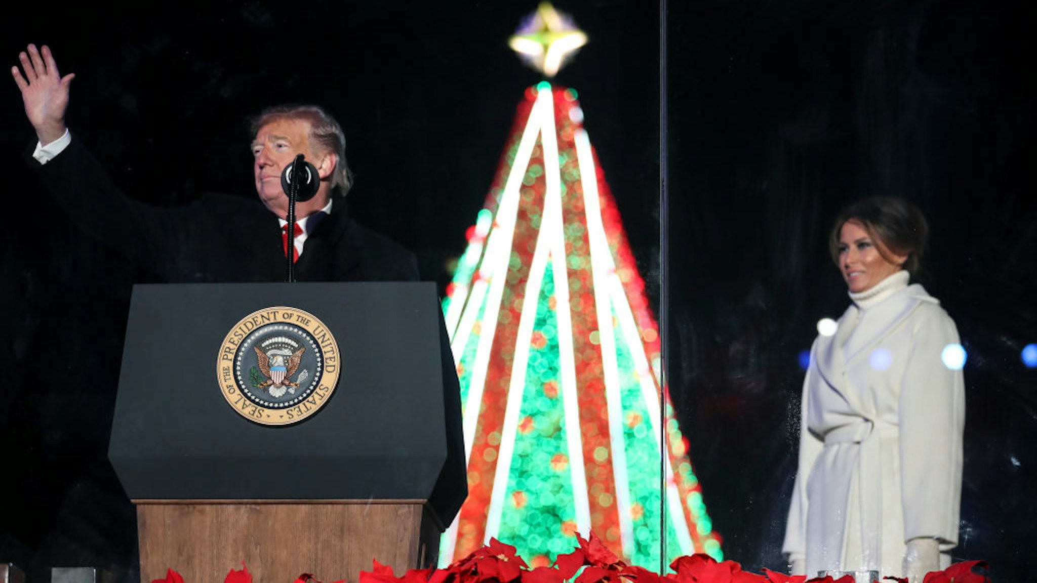 President Donald Trump waves to the audience during the National Christmas Tree lighting ceremony held by the National Park Service at the Ellipse near the White House on November 28, 2018 in Washington, DC.