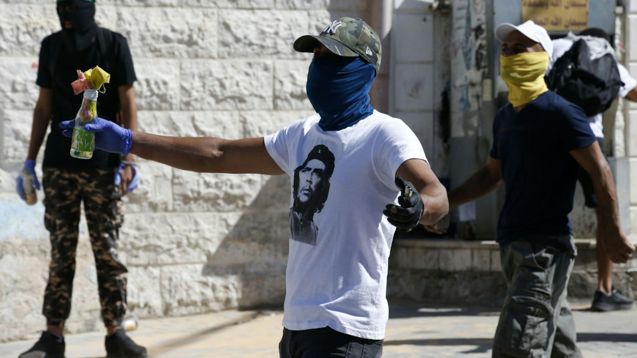 Masked Palestinian protesters throw molotov cocktails at Israeli security forces amidst clashes following Friday prayers in the Jerusalem Arab neighbourhood of Issawiya on June 28, 2019, after a Palestinian demonstrator died from injuries sustained the previous day.