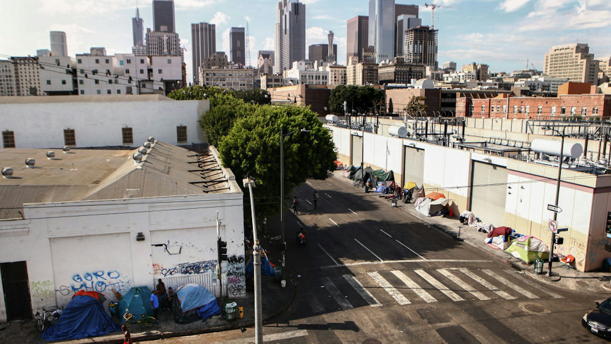 A man walks past a homeless tent encampment in Skid Row on September 16, 2019 in Los Angeles, California.