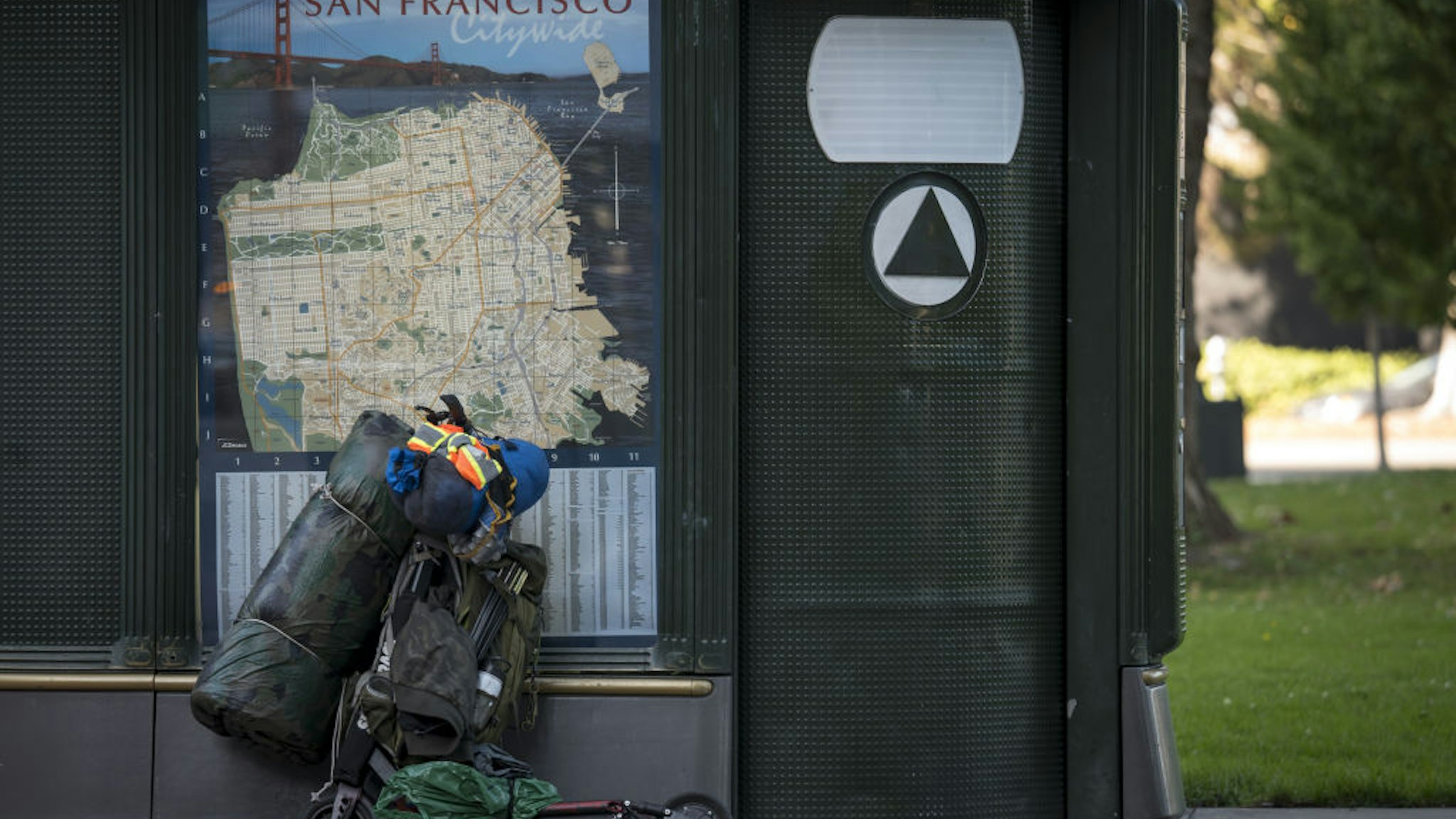 A scooter loaded with personal items stands against a public toilet in San Francisco, California, U.S., on Monday, Oct. 14, 2019.
