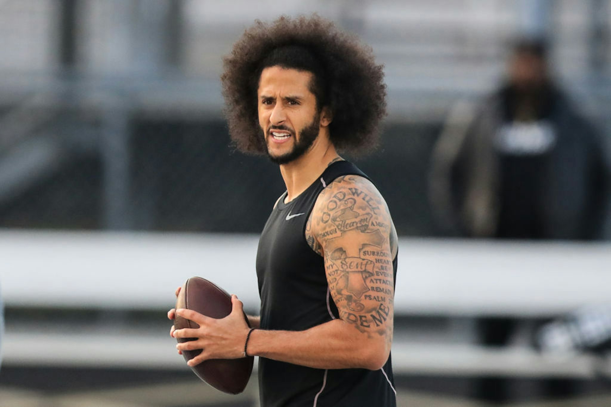 Colin Kaepernick looks to make a pass during a private NFL workout held at Charles R Drew high school on November 16, 2019 in Riverdale, Georgia.