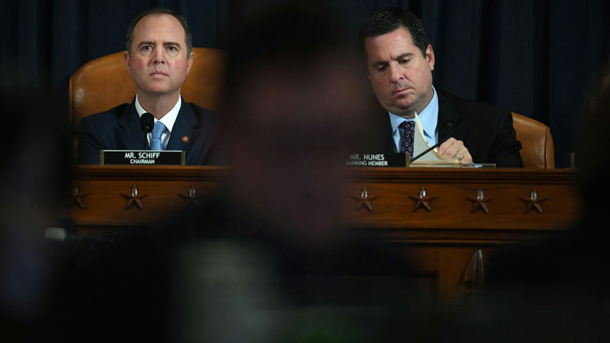 House Intelligence Committee chair, Adam Schiff (D-CA) and U.S. Representative Devin Nunes (R-CA) are seen as David A. Holmes, Department of State political counselor for the United States Embassy in Kyiv, Ukraine and Dr. Fiona Hill, former National Security Council senior director for Europe and Russia appear before the House Intelligence Committee during an impeachment inquiry hearing at the Longworth House Office Building on Thursday November 21, 2019 in Washington, DC.