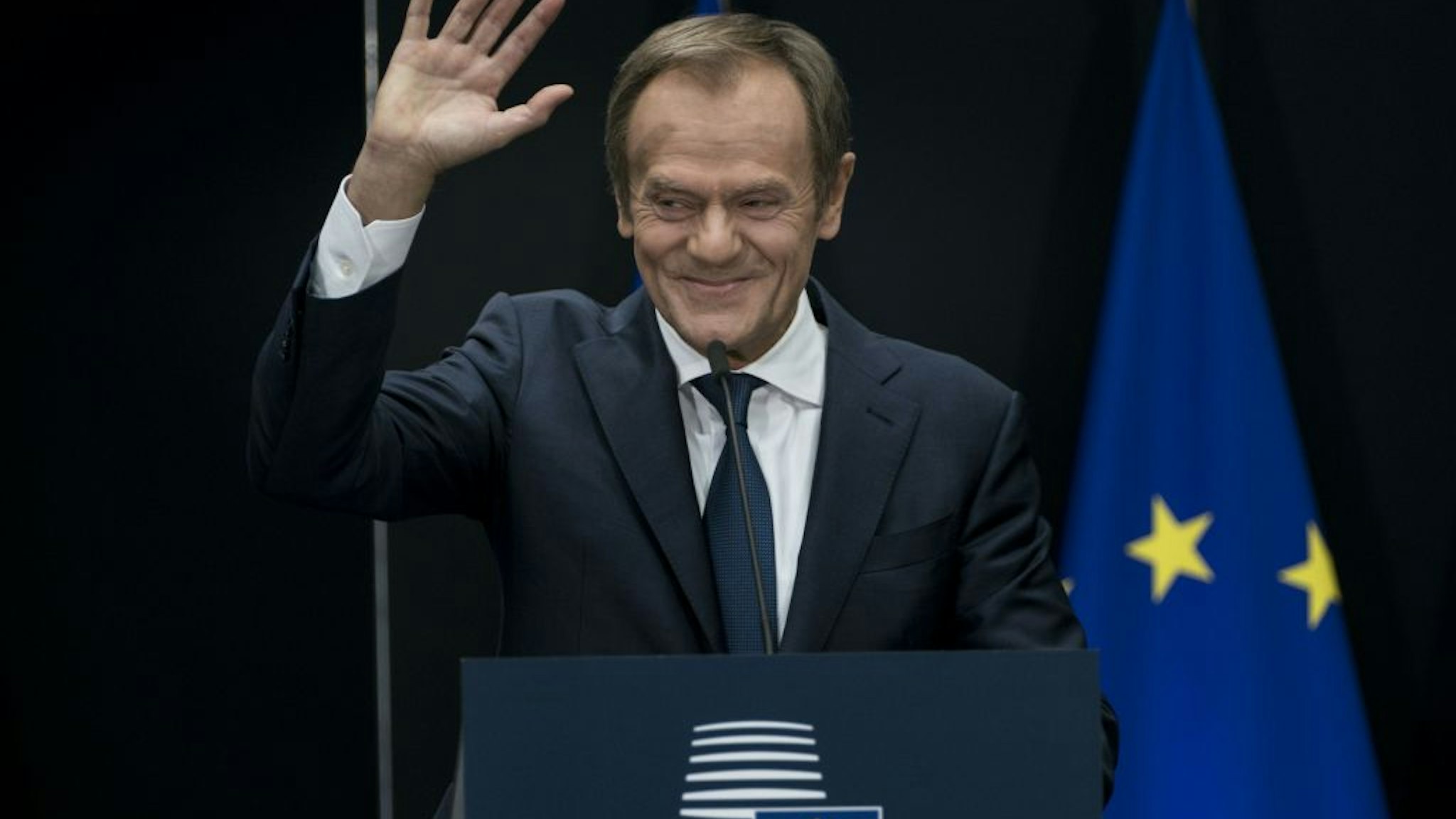 Outgoing European Council President Donald Tusk waves during the handover ceremony between Tusk and his successor, at the European headquarters in Brussels, on November 29, 2019.