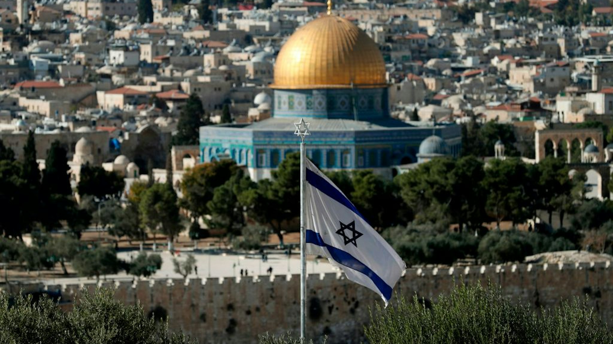 A picture taken from the Mount of Olives shows an Israeli flag fluttring as Jerusalem's Old City and its Dome of the Rock mosque in the centre on November 29, 2019