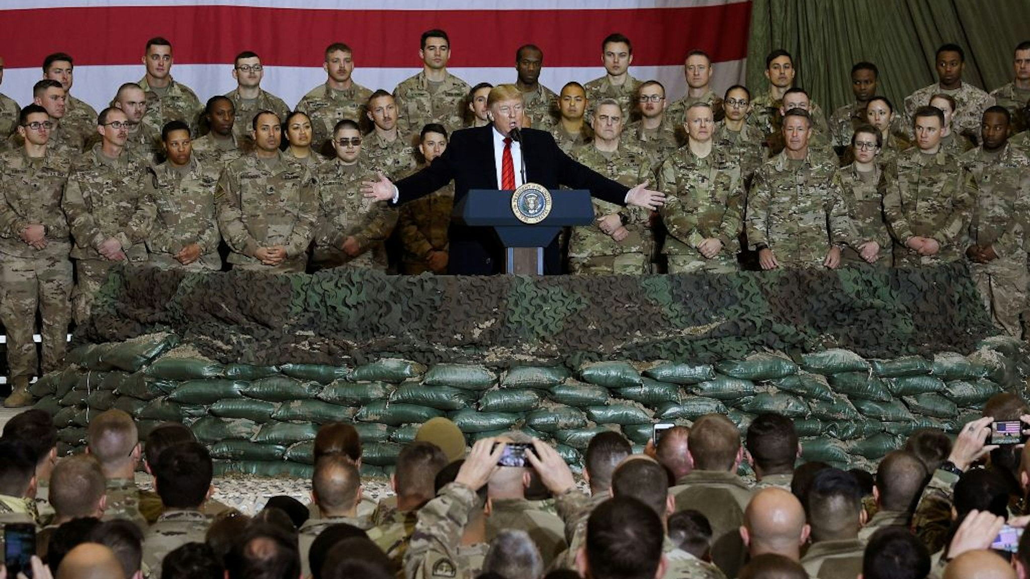 In this file photo taken on November 28, 2019, US President Donald Trump speaks to the troops during a surprise Thanksgiving day visit at Bagram Air Field in Afghanistan.