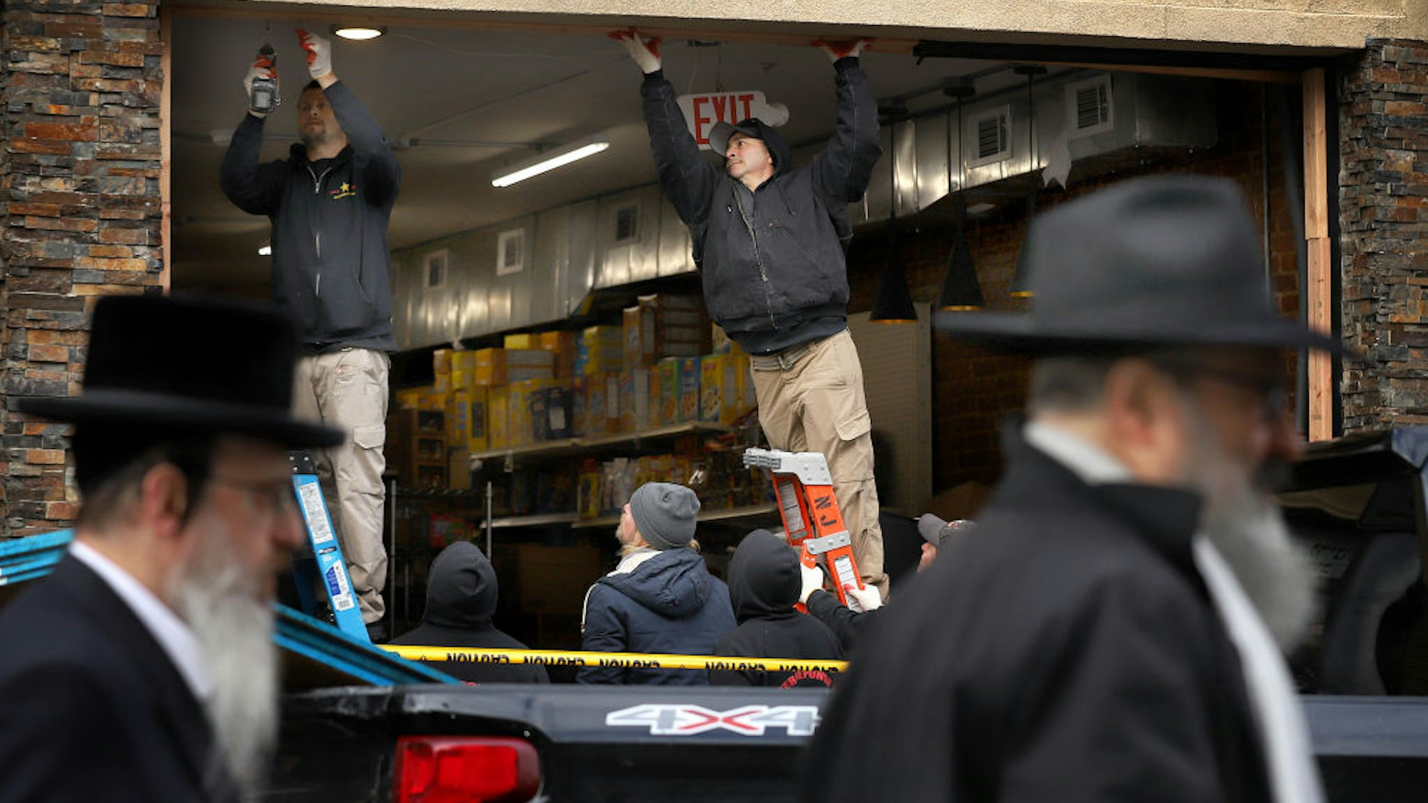 JERSEY CITY, NJ - DECEMBER 11: Recovery and clean up crews work the scene in the aftermath of a mass shooting at the JC Kosher Supermarket on December 11, 2019 in Jersey City, New Jersey. Six people, including a Jersey City police officer and three civilians were killed in a deadly, hours-long gun battle between two armed suspects and police on Tuesday in a standoff and shootout in a Jewish market that appears to have been targeted, according to Jersey City Mayor Steven Fulop.