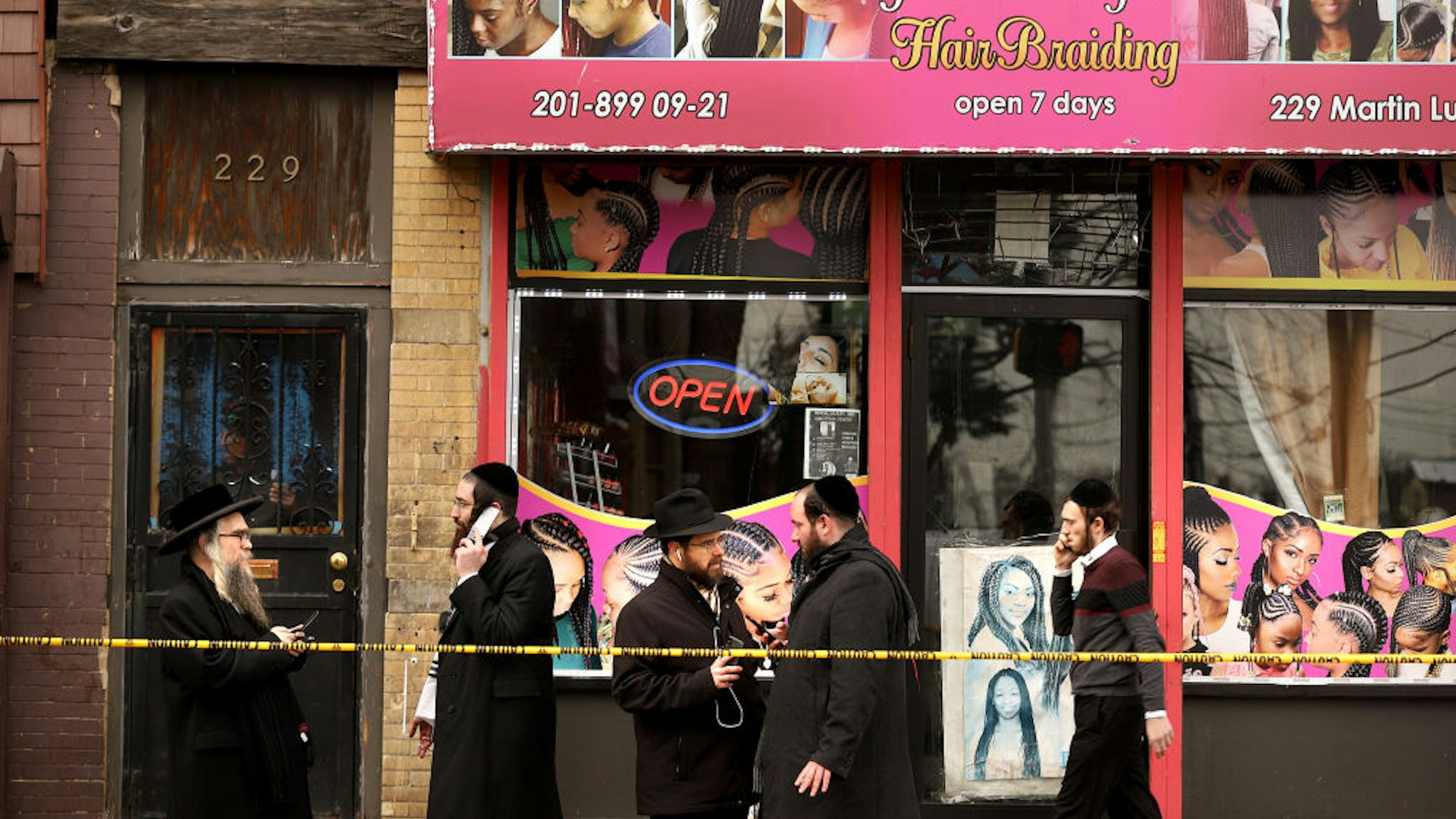 Members of the Jewish community pass by near the scene of a mass shooting at the JC Kosher Supermarket on December 11, 2019 in Jersey City, New Jersey.