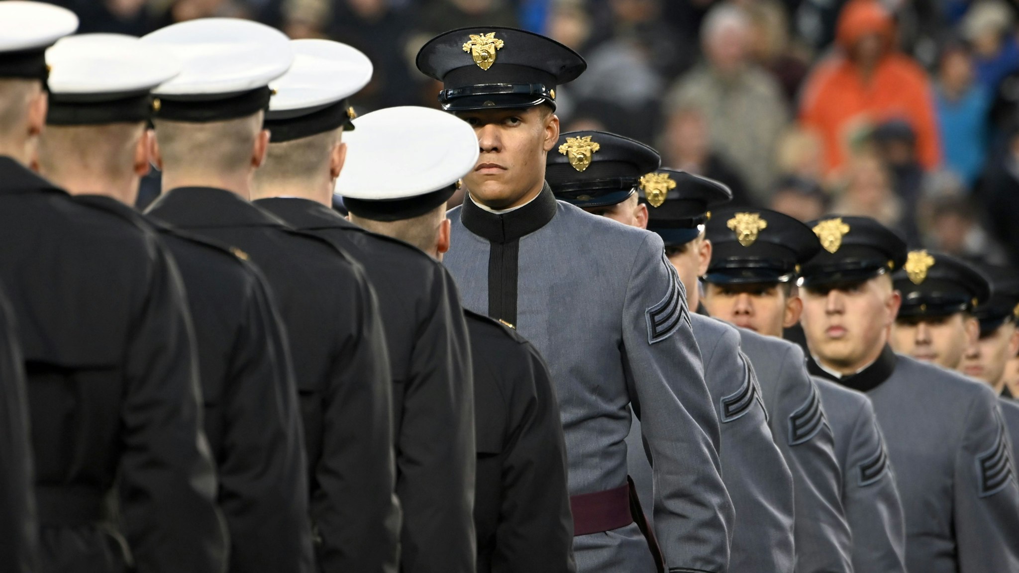 Army and Navy members meet half way as US President Donald Trump attends the Army-Navy football game in Philadelphia, Pennsylvania on December 14, 2019. (Photo by Andrew Caballero-Reynolds / AFP) (Photo by ANDREW CABALLERO-REYNOLDS/AFP via Getty Images)