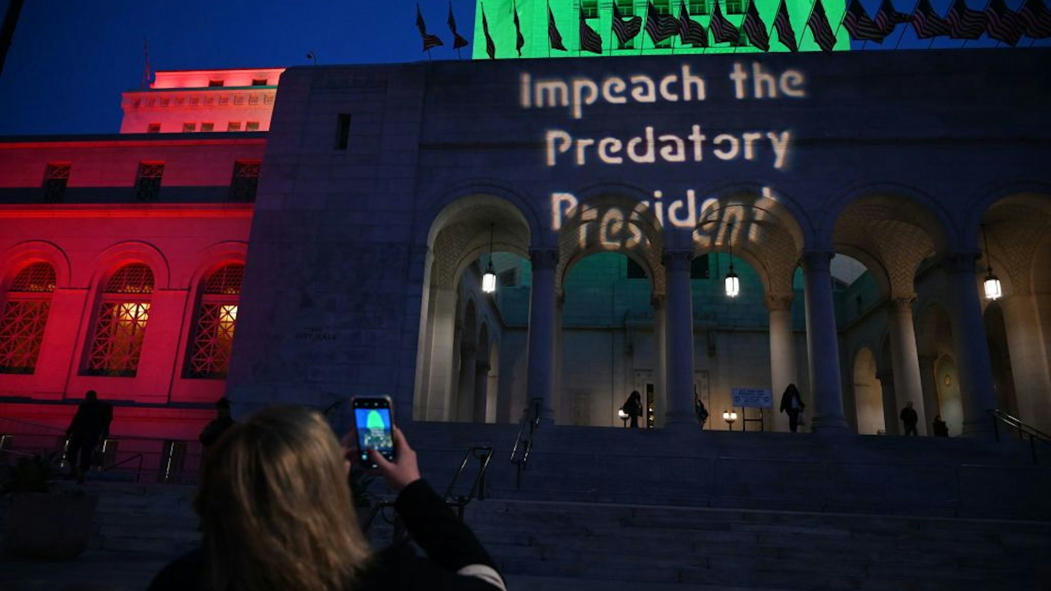 A message pro-impeachment is projected on the facade of the City Hall building before the start of a protest in Los Angeles on December 17, 2019.