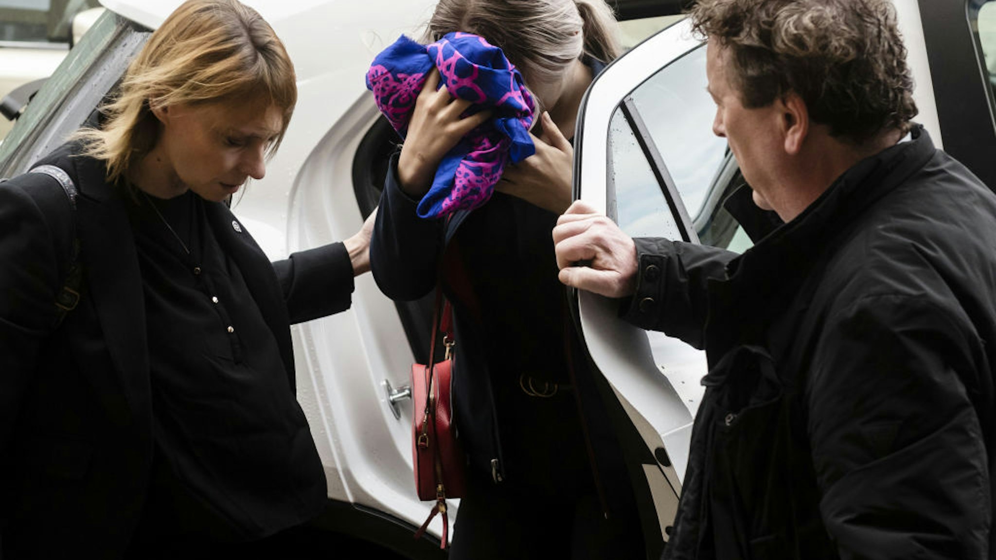 A British teenager (C) accused of falsely claiming she was raped by Israeli tourists, covers her face as she arrives for her trial at the Famagusta District Court in Paralimni in eastern Cyprus, on December 30, 2019.