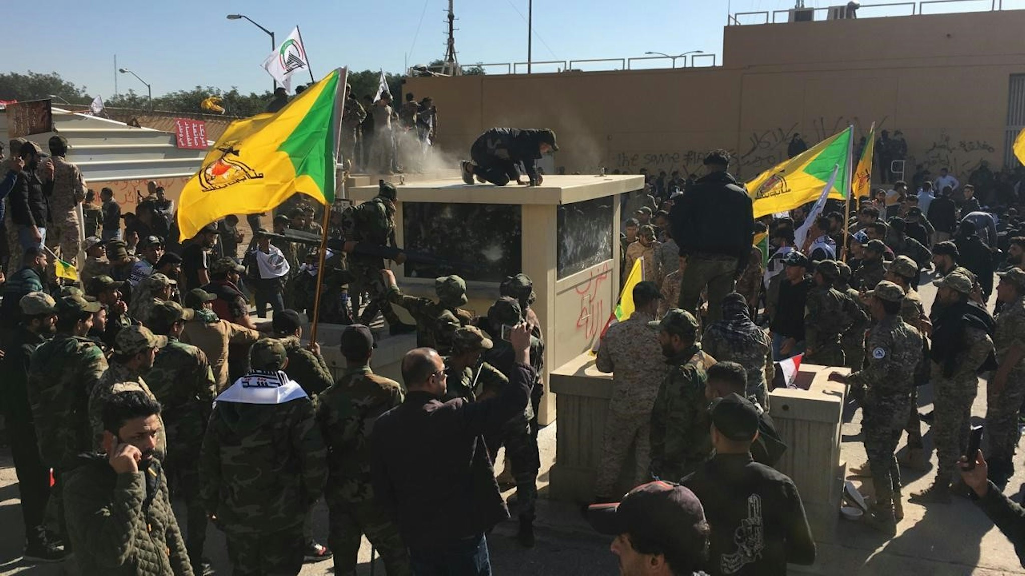 DECEMBER 31: Outraged Iraqi protesters try to storm the U.S. Embassy in Baghdad, protesting Washington's attacks on armed battalions belong to Iranian-backed Hashd al-Shaabi forces on December 31, 2019. At least 25 people were killed in weekend U.S. airstrikes on positions of Kataib Hezbollah, an Iranian-backed militia group, in Iraq and Syria. Hundreds of Iraqi protesters gathered early Tuesday near the embassy to show their anger at the U.S. move.