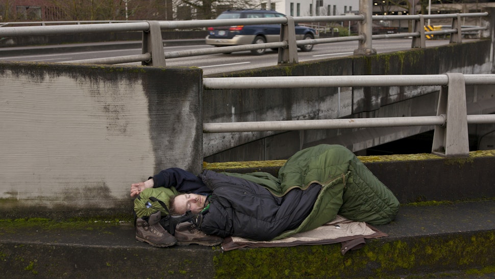 ORTLAND, OR - FEBRUARY 11: A homeless man sleeps on a downtown roadway overpass on February 11, 2012 in Portland, Oregon. Portland has embraced its national reputation as a city inhabited by weird, independent people, as underscored in the dark comedy IFC TV show "Portlandia." (Photo by George Rose/Getty Images)