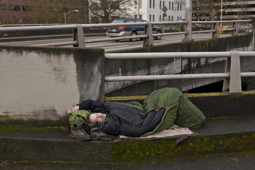 ORTLAND, OR - FEBRUARY 11: A homeless man sleeps on a downtown roadway overpass on February 11, 2012 in Portland, Oregon. Portland has embraced its national reputation as a city inhabited by weird, independent people, as underscored in the dark comedy IFC TV show "Portlandia." (Photo by George Rose/Getty Images)