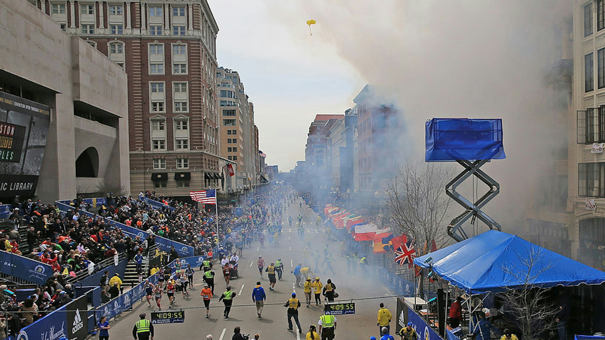 Emergency personnel respond to the scene after two explosions went off near the finish line of the 117th Boston Marathon on April 15, 2013.