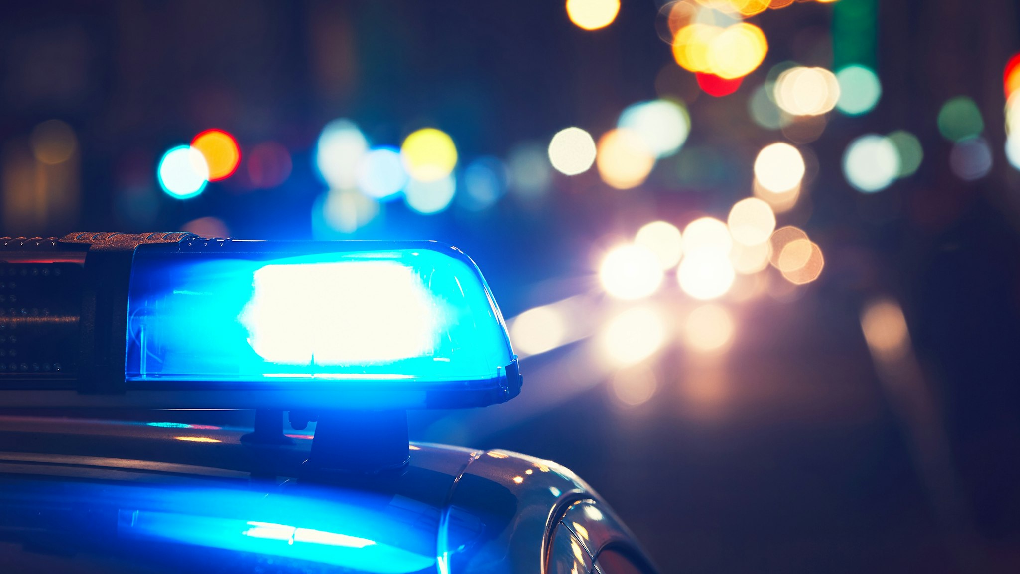 Close-Up Of Blue Siren On Police Car At Night - stock photo
