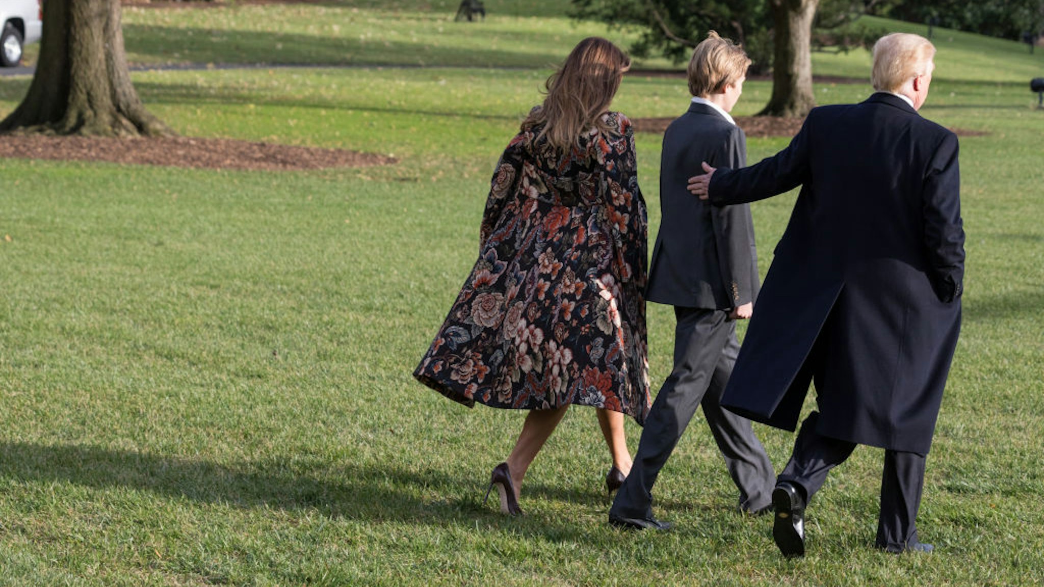President Donald Trump leaves the White House with First Lady Melania Trump and son Barron Trump, as they depart for the Thanksgiving Holiday from the South Lawn of the White House in Washington, DC, on November 21, 2017.