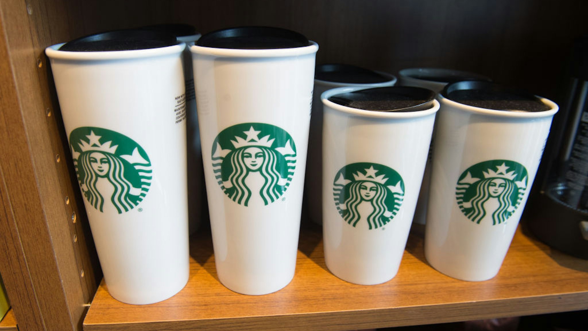 Starbucks coffee mugs are for sale inside a Starbucks Coffee shop in Washington, DC, April 17, 2018.