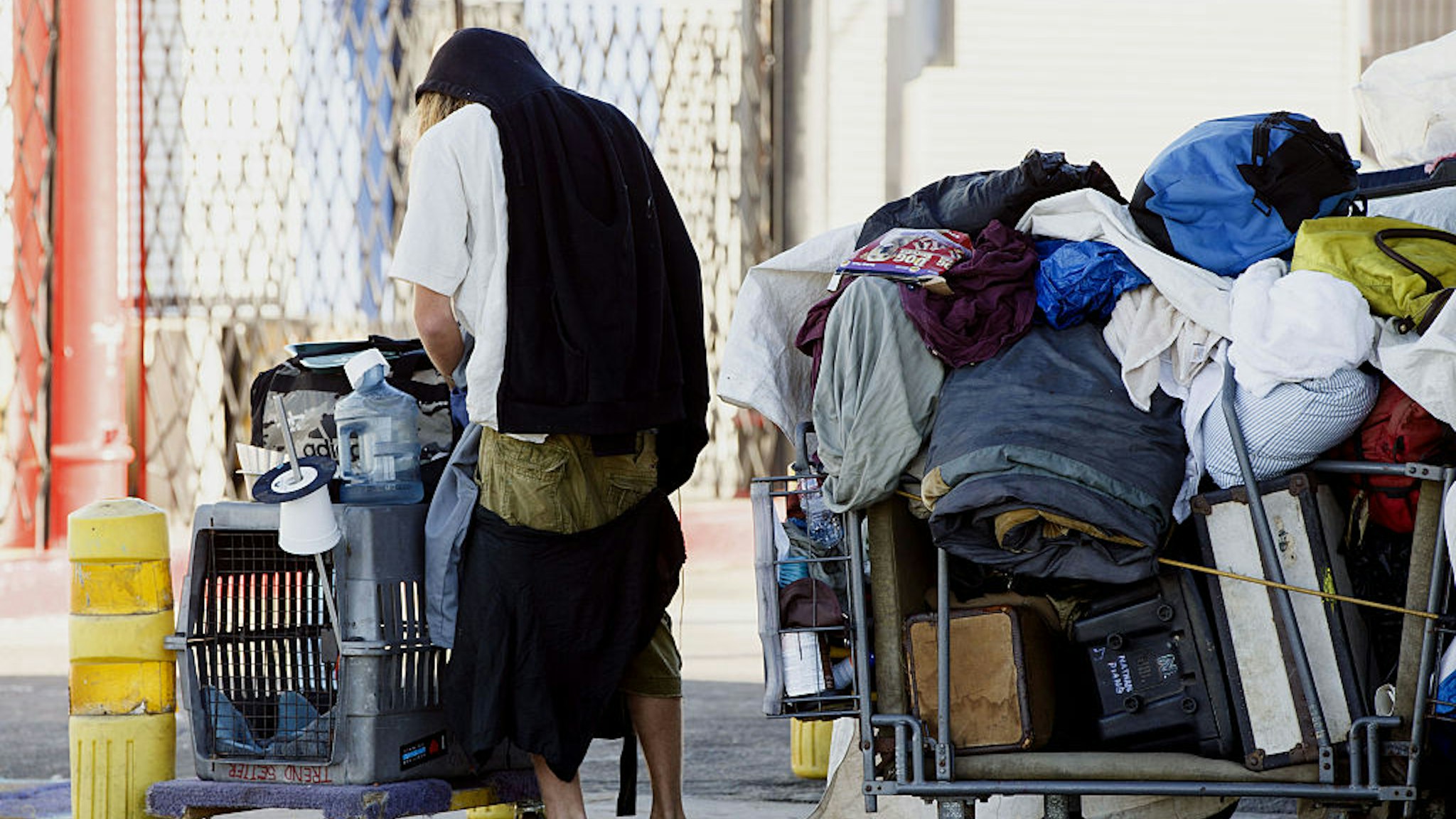 A man pushes a cart on the Venice Beach boardwalk in Los Angeles, California, U.S., on Friday, Oct. 9, 2015. Homelessness is on the rise in many of America's biggest cities as wealth concentrates in urban centers, elevating rents and squeezing supplies of affordable housing in places like Los Angeles and New York, new federal data shows. Photographer: Patrick T. Fallon/Bloomberg via Getty Images