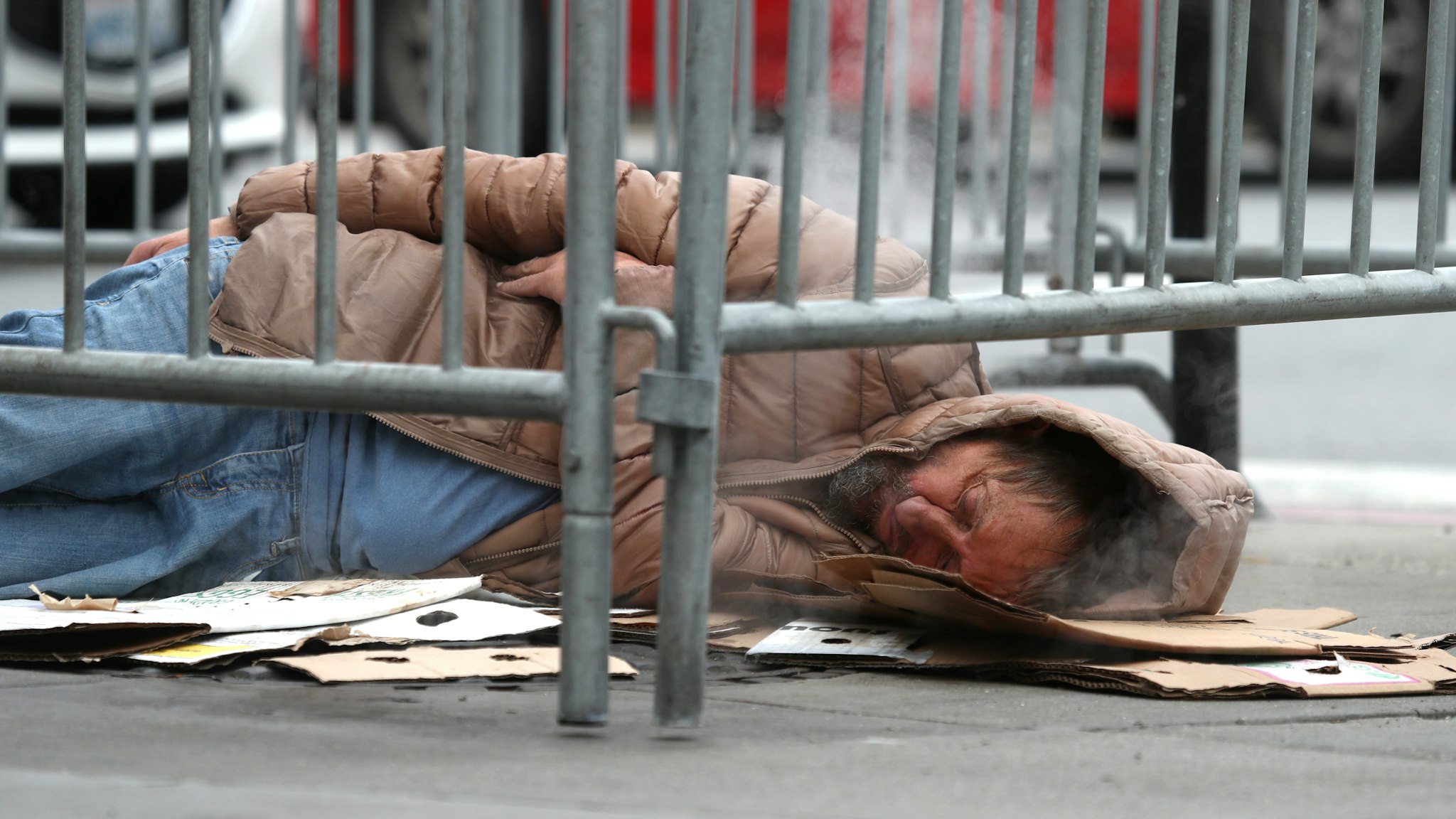 DECEMBER 05: A homeless man sleeps on the sidewalk on December 05, 2019 in San Francisco, California. California Gov. Gavin Newsom announced plans to release $650 million in emergency aid that will allocated to California cities and counties in an effort to combat the state's homelessness crisis.