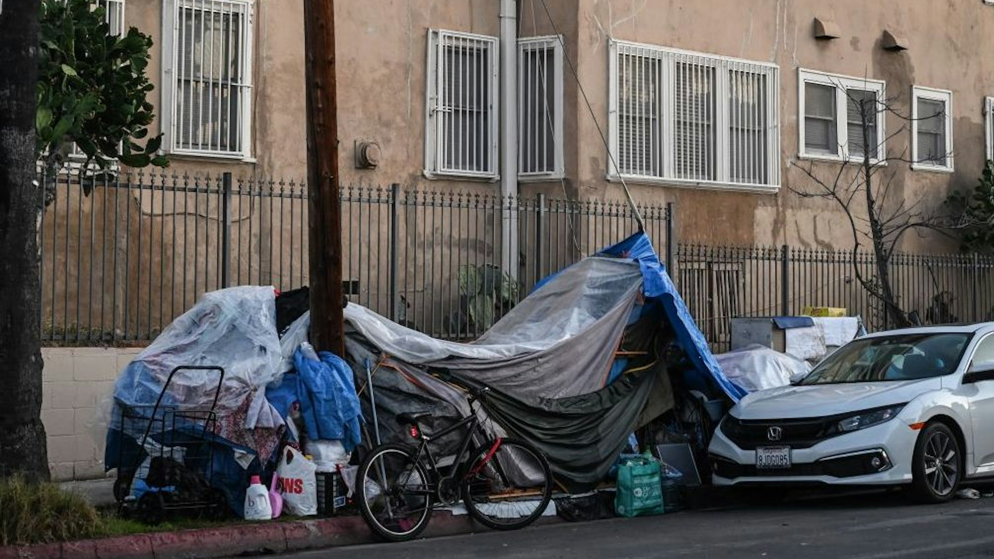 Tents sheltering homeless people line a residential street in Los Angeles, California, December 9, 2019. - At the behest of Los Angeles and local governments across the west, the US Supreme Court is considering a ruling by the 9th Circuit Court of Appeals that requires cities to allow people to sleep in public places including sidewalks as long as there are not enough public shelter beds for every person in need. Over half a million people in the US are homeless on a single night, according to a report released in September by the White House's The Council of Economic Advisers.