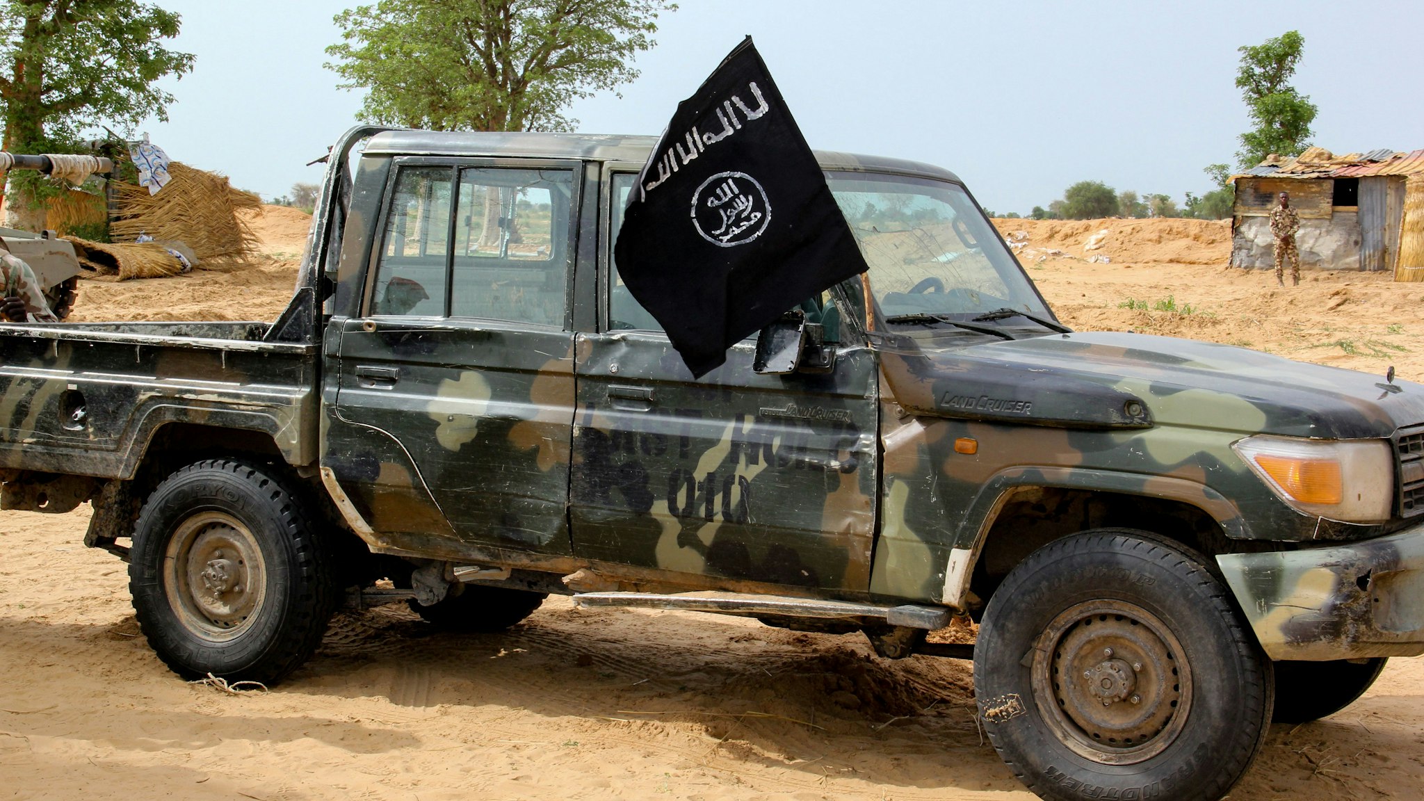 A vehicle allegedly belonging to the Islamic State group in West Africa (ISWAP) is seen in Baga on August 2, 2019. - Intense fighting between a regional force and the Islamic State group in West Africa (ISWAP) has resulted in dozens of deaths, including at least 25 soldiers and more than 40 jihadists, in northeastern Nigeria. ISWAP broke away from Boko Haram in 2016 in part due to its rejection of indiscriminate attacks on civilians. Last year the group witnessed a reported takeover by more hardline fighters who sidelined its leader and executed his deputy. The IS-affiliate has since July 2018 ratcheted up a campaign of attacks against military targets.
