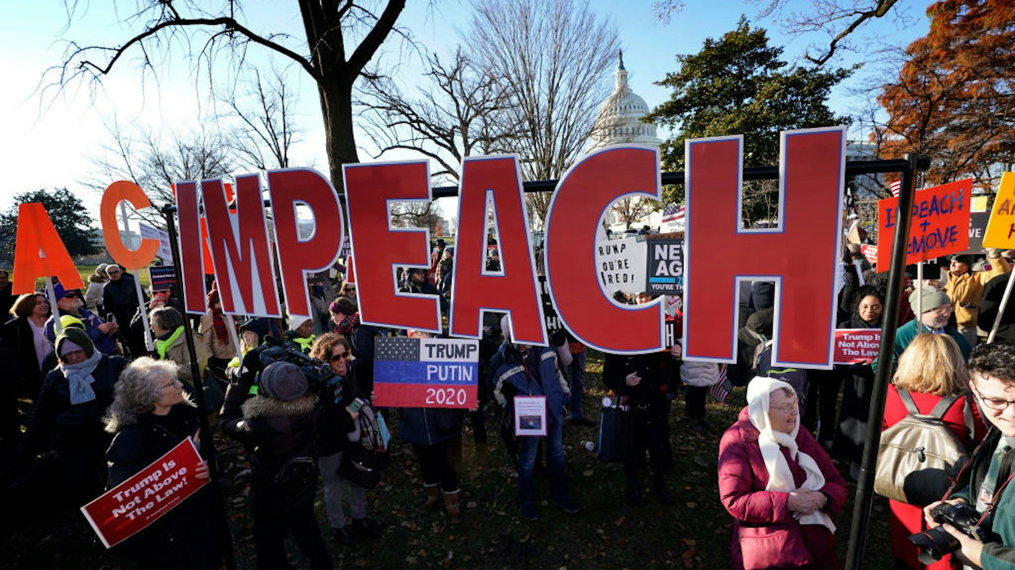 Protesters supporting the impeachment of U.S. President Donald Trump gather outside the U.S. Capitol December 18, 2019 in Washington, DC. Later today the U.S. House of Representatives is expected to vote on two articles of impeachment against Trump charging him with abuse of power and obstruction of Congress. (Photo by Win McNamee/Getty Images)
