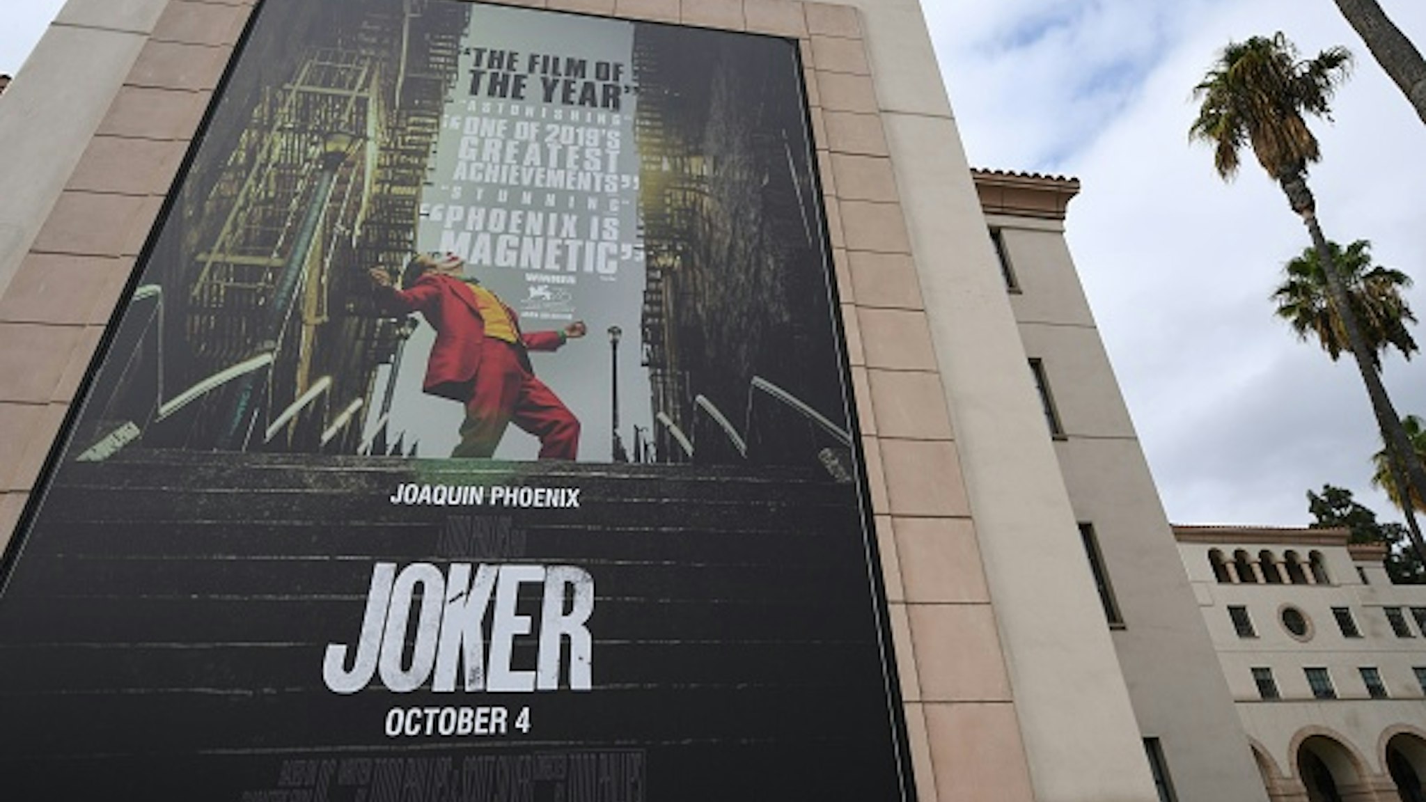 A poster for the upcoming film "The Joker" is seen outside Warner Brothers Studios in Burbank, California, September 27, 2019. - The Los Angeles Police Department said Friday it plans to step up its visibility around movie theaters for the opening of "Joker" because of heightened fears over the film's content.