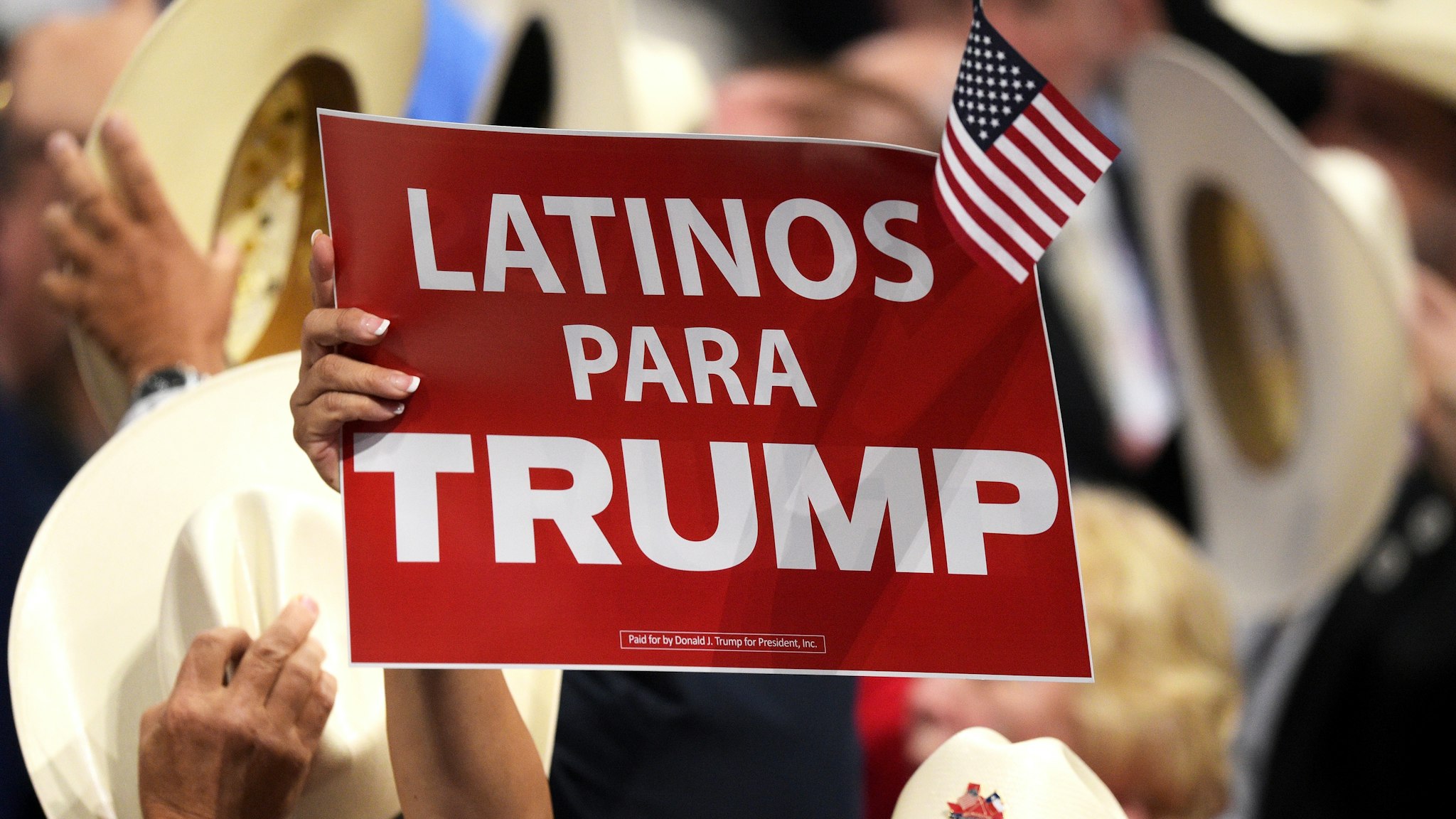 CLEVELAND, OH - JULY 21: A delegate holds up sign that reads "Latinos Para Trump" during the evening session on the fourth day of the Republican National Convention on July 21, 2016 at the Quicken Loans Arena in Cleveland, Ohio. Republican presidential candidate Donald Trump received the number of votes needed to secure the party's nomination. An estimated 50,000 people are expected in Cleveland, including hundreds of protesters and members of the media. The four-day Republican National Convention kicked off on July 18.