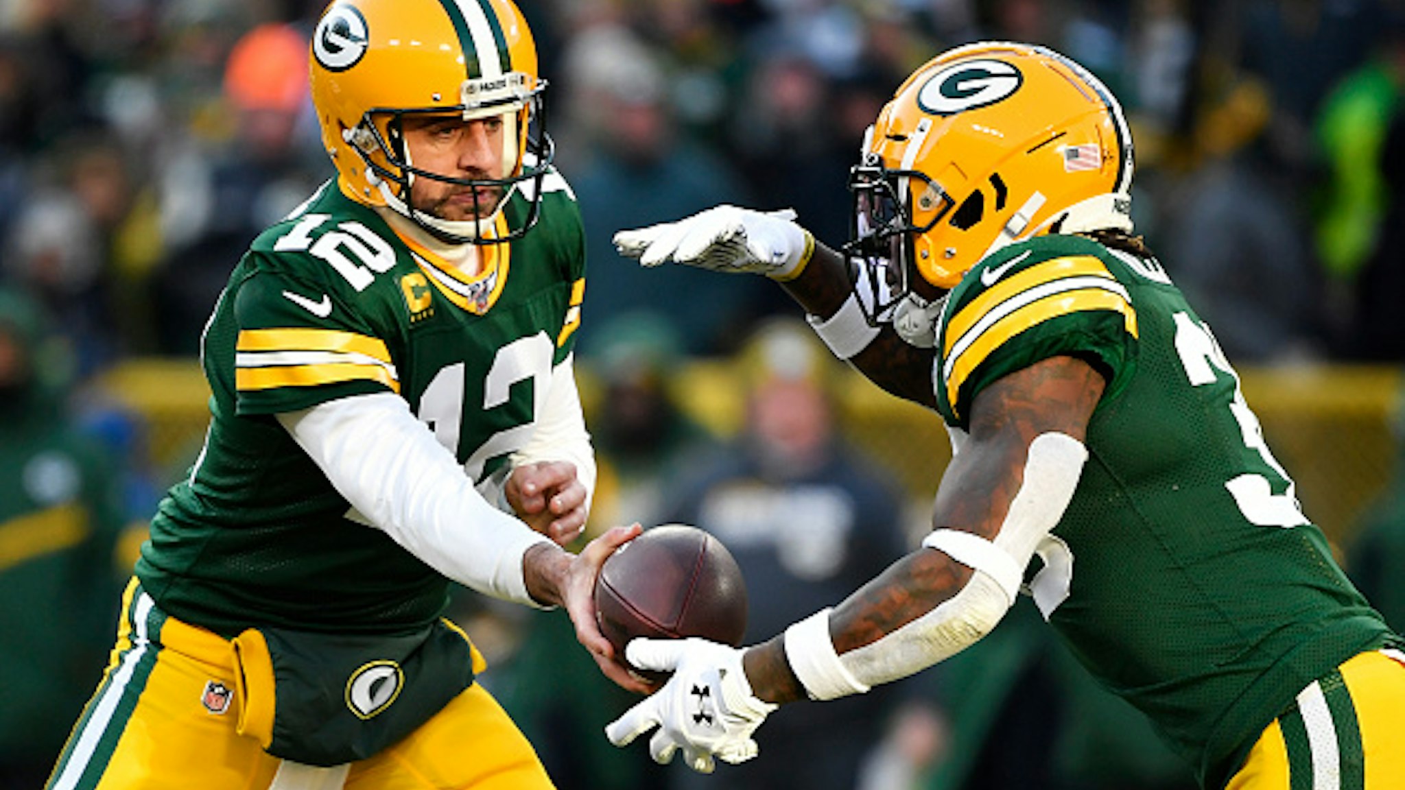 GREEN BAY, WISCONSIN - DECEMBER 15: Aaron Rodgers #12 of the Green Bay Packers hands the football off during the game against the Chicago Bears at Lambeau Field on December 15, 2019 in Green Bay, Wisconsin.